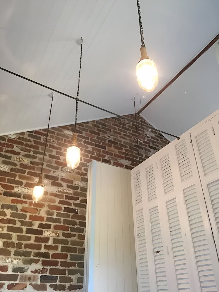 A Room With A Brick Wall And White Shutters And Ceiling — In-Line Electrical Southern Highlands in Moss Vale, NSW