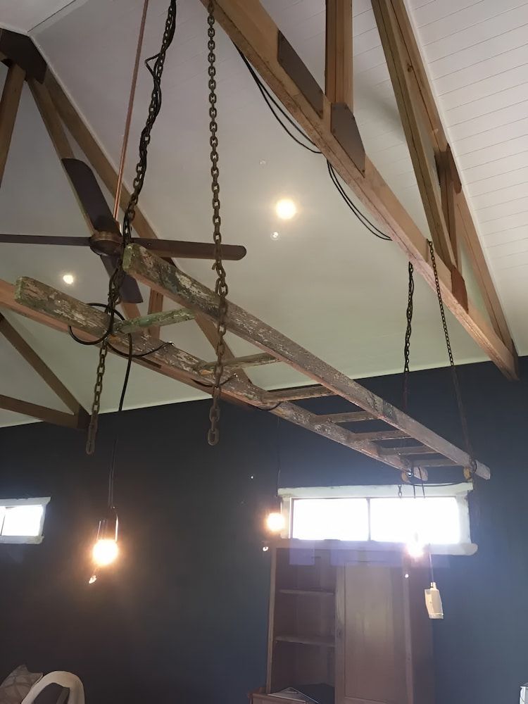 A Wooden Ladder Is Hanging From The Ceiling In A Room — In-Line Electrical Southern Highlands in Carrick, NSW