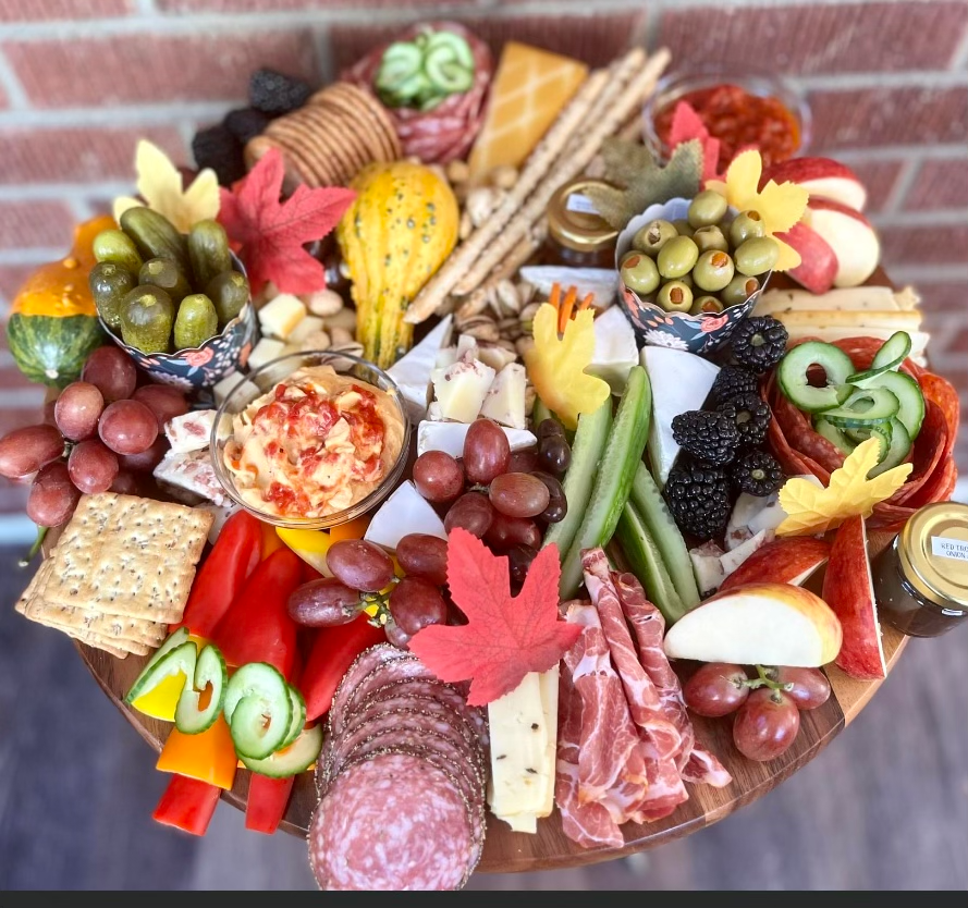 A wooden tray filled with a variety of fruits and vegetables
