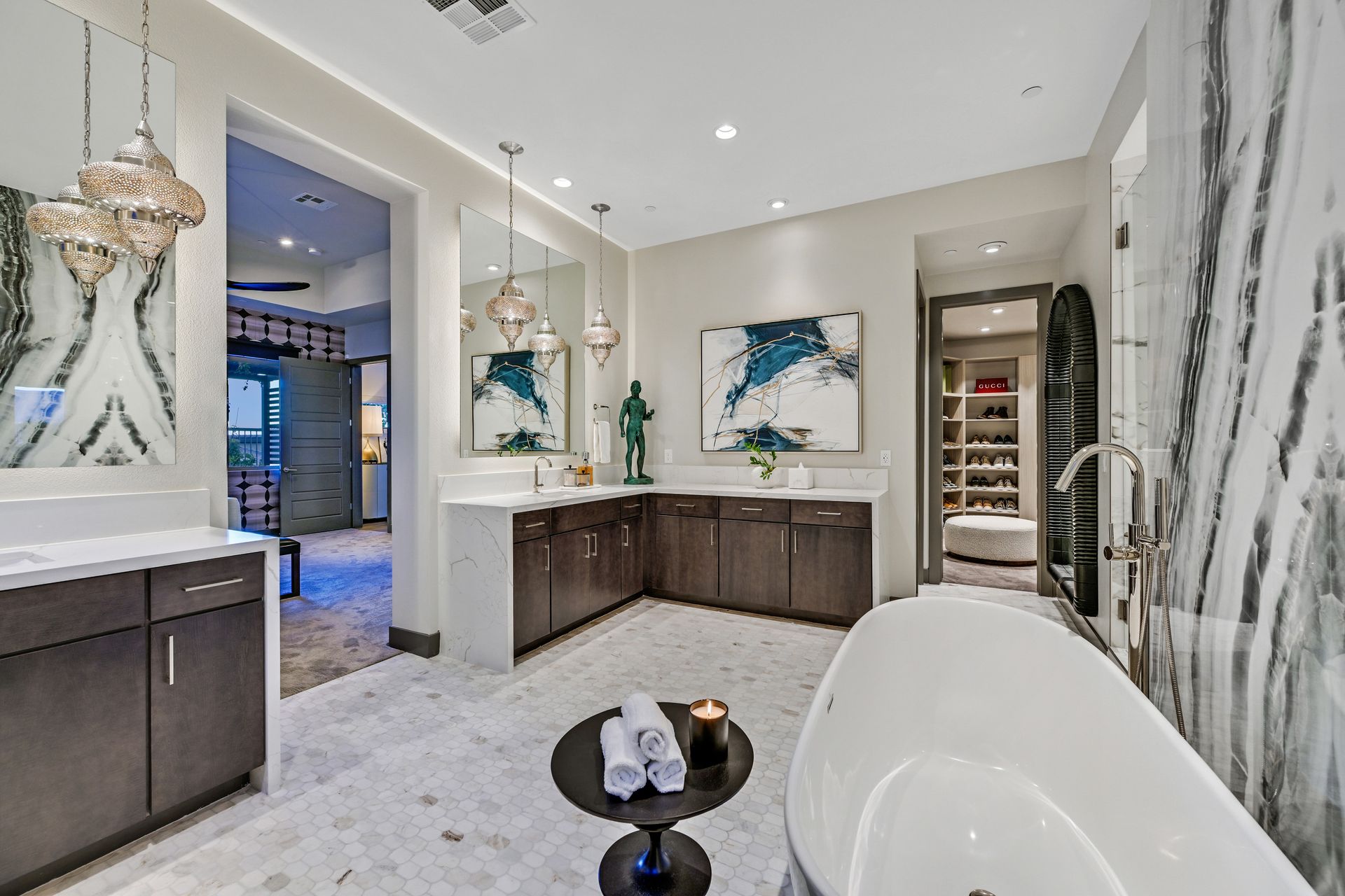 Luxurious bathroom with marble accents, freestanding tub, and dark wood cabinetry.