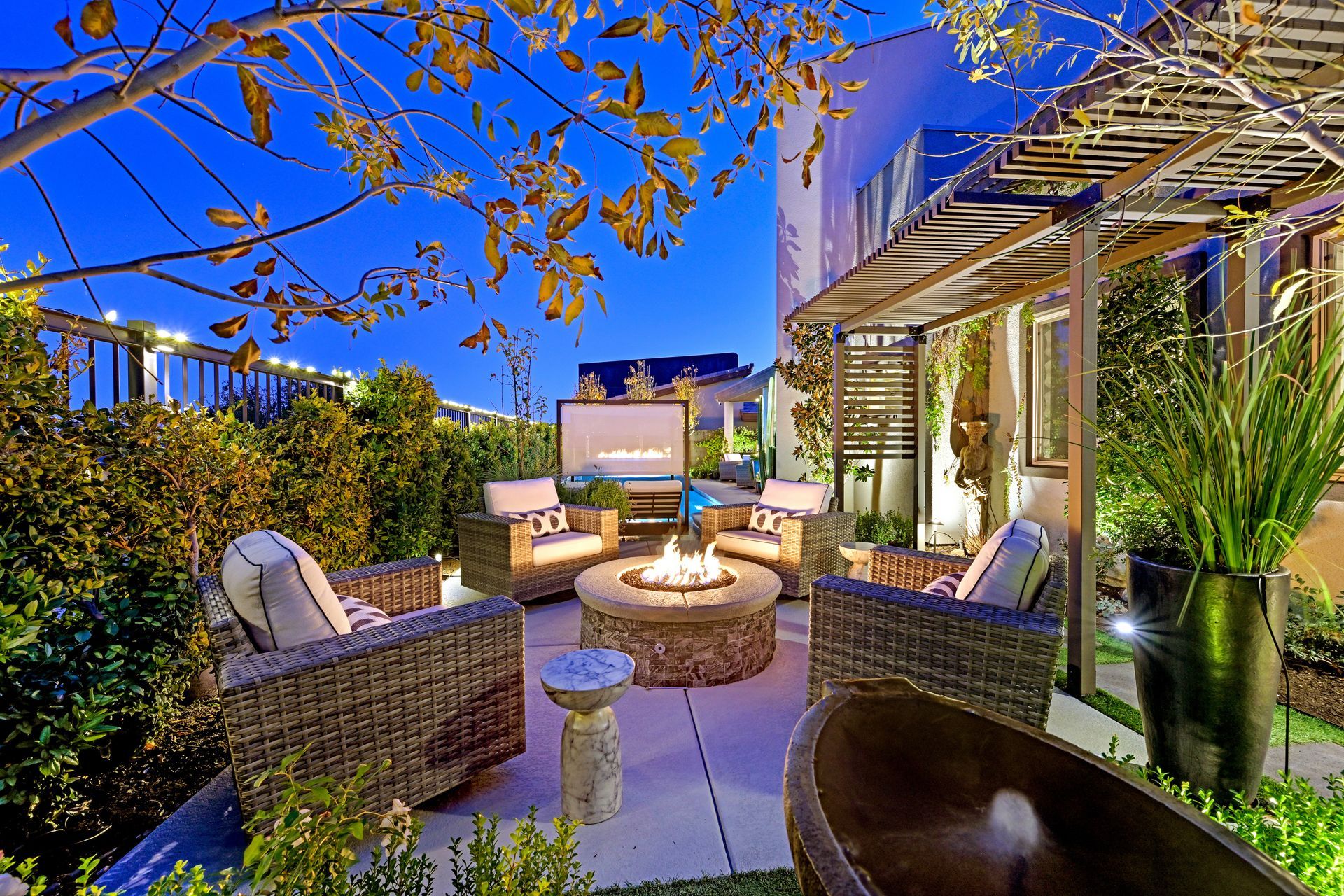 Luxurious living room with white decor, high ceilings, large windows, and a patio view.