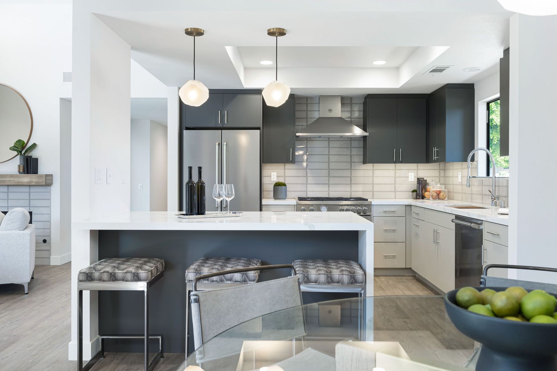 A kitchen with stainless steel appliances and black cabinets