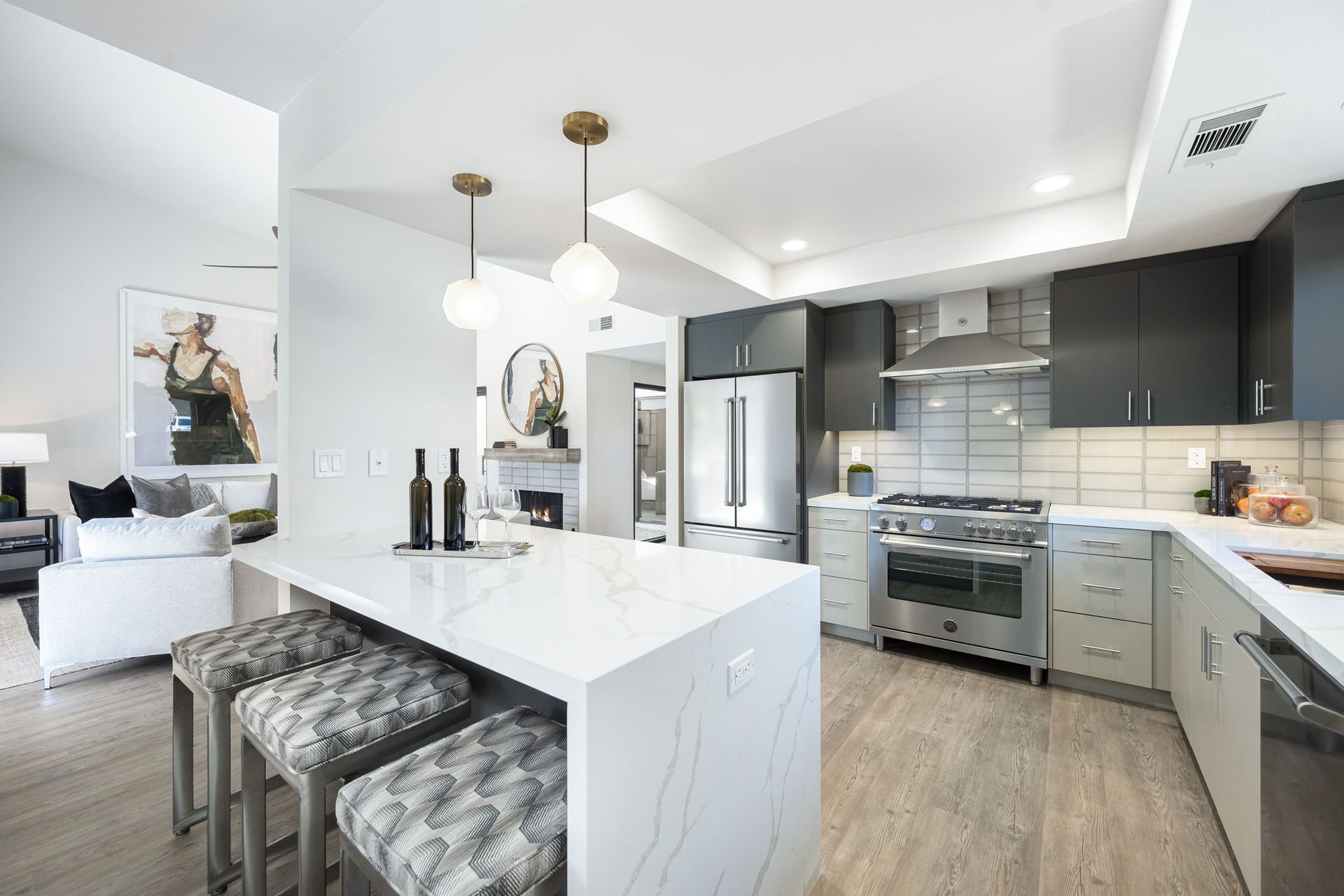 A kitchen with stainless steel appliances and a large island.