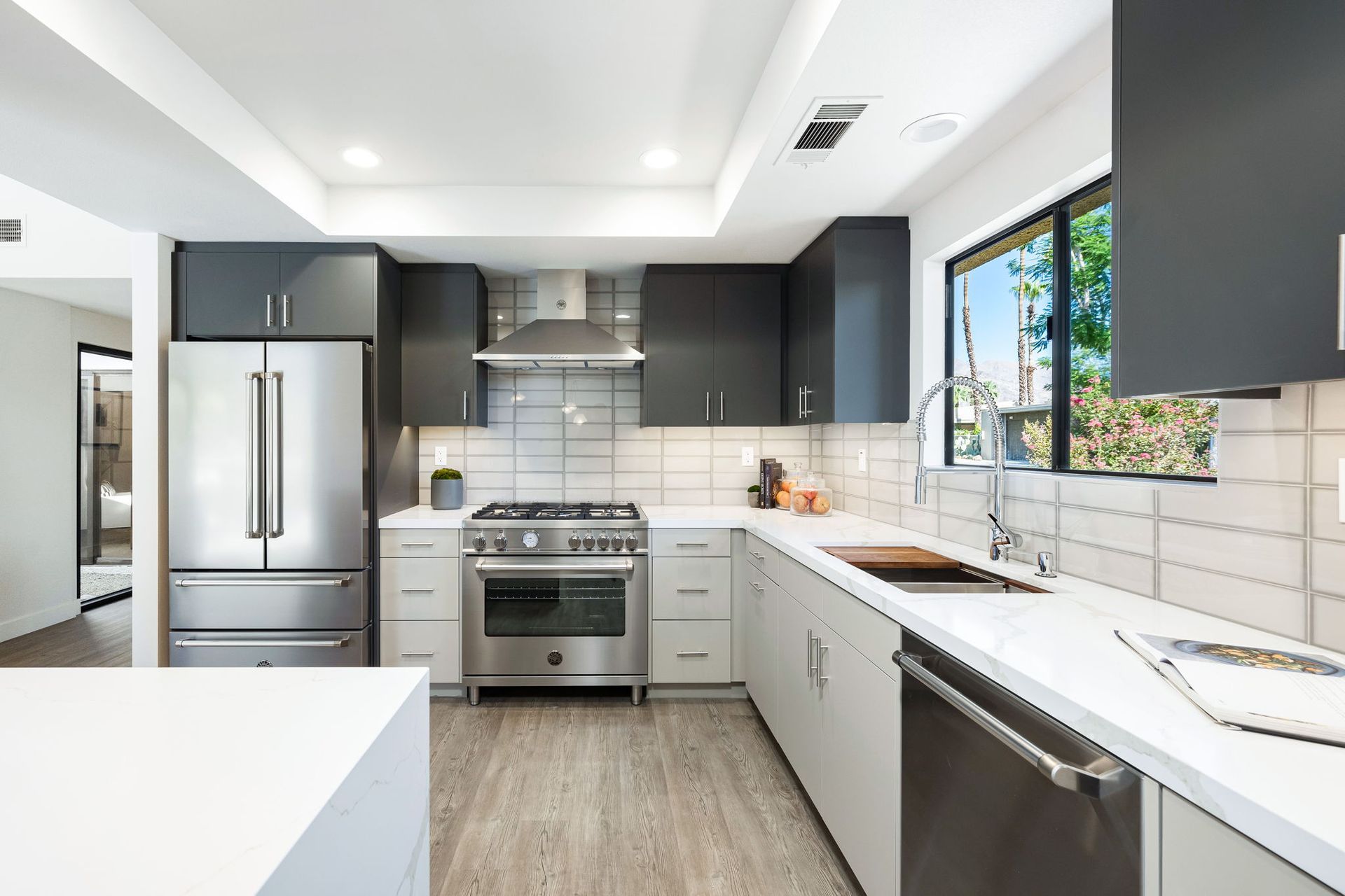 A kitchen with stainless steel appliances and black cabinets