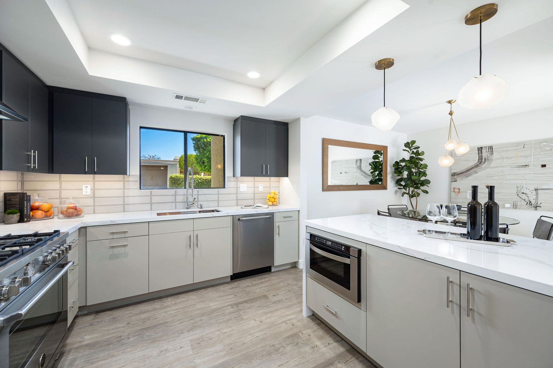A kitchen with stainless steel appliances and white cabinets.