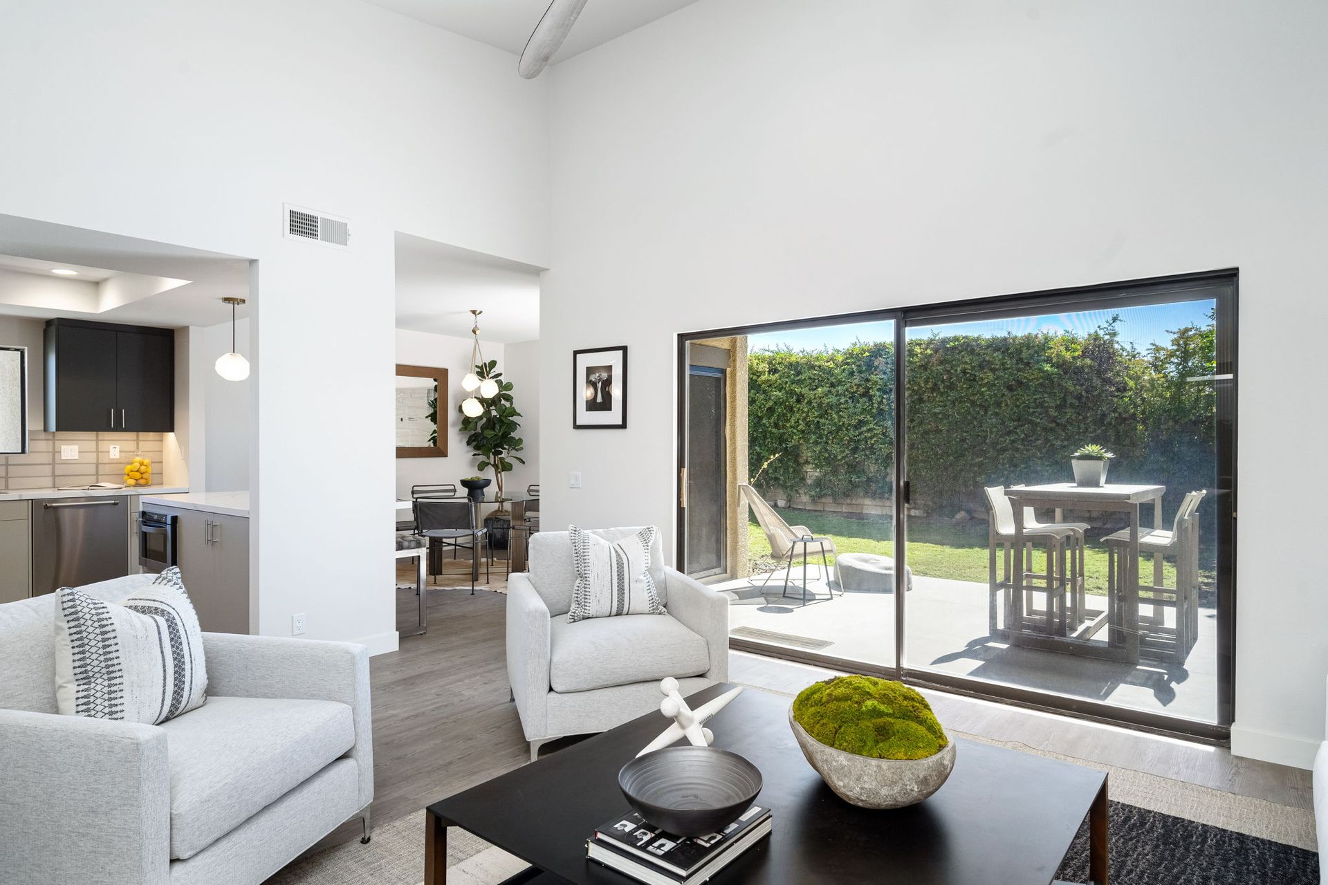 A living room with sliding glass doors leading to a patio.