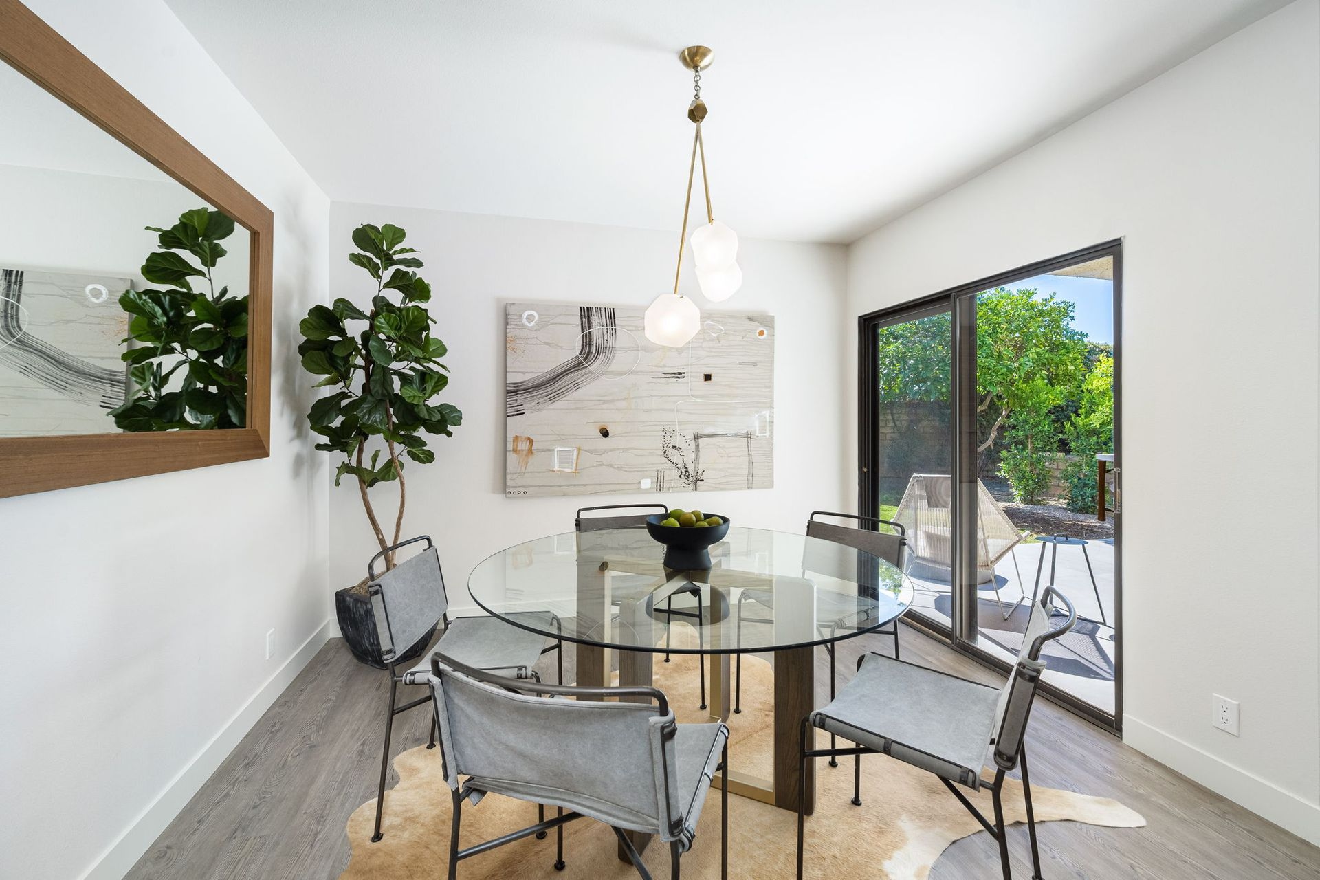 A dining room with a glass table and chairs