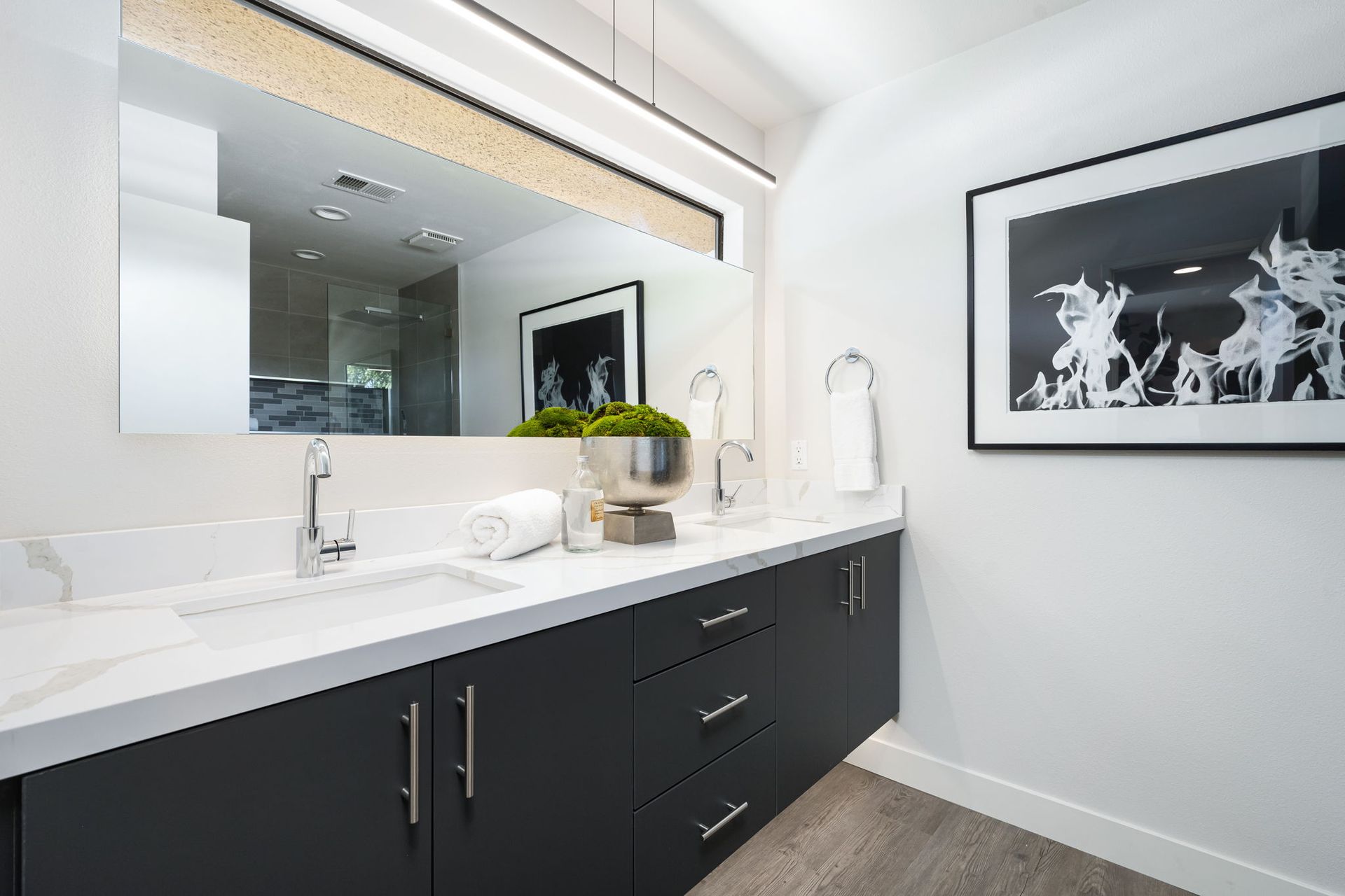 A bathroom with two sinks and a large mirror.