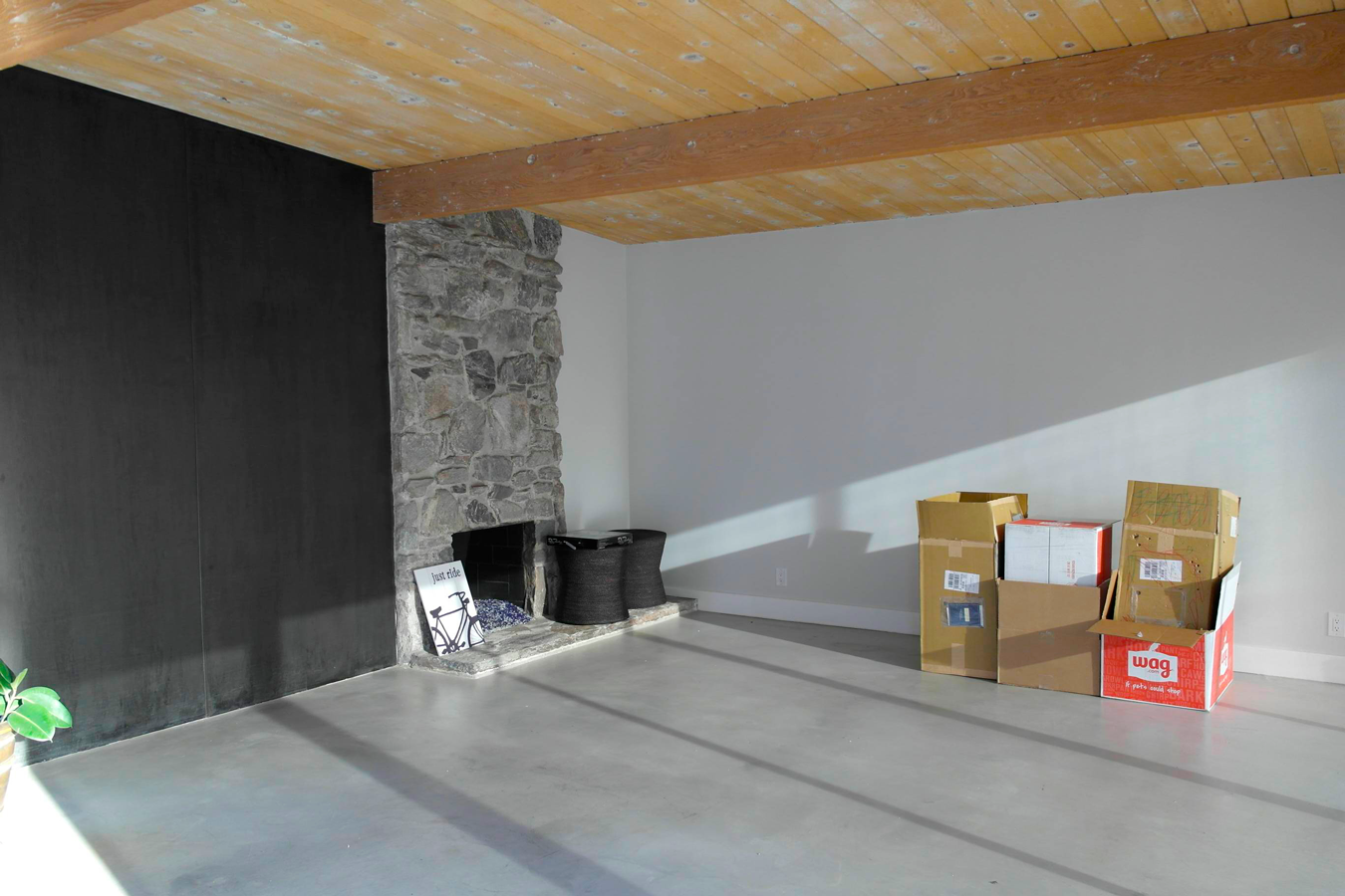 A living room with a fireplace and boxes on the floor