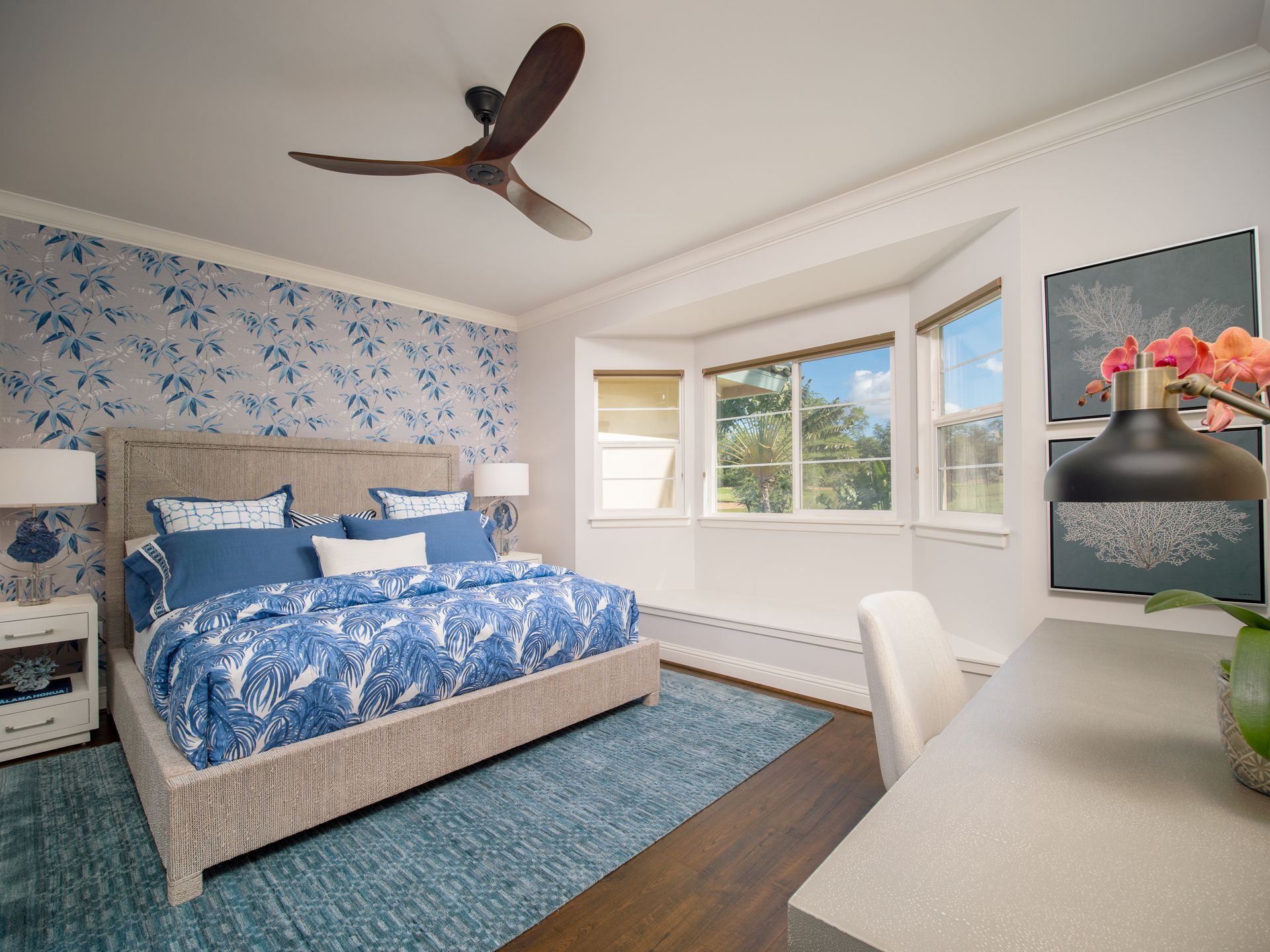 A bedroom with a large bed and a ceiling fan