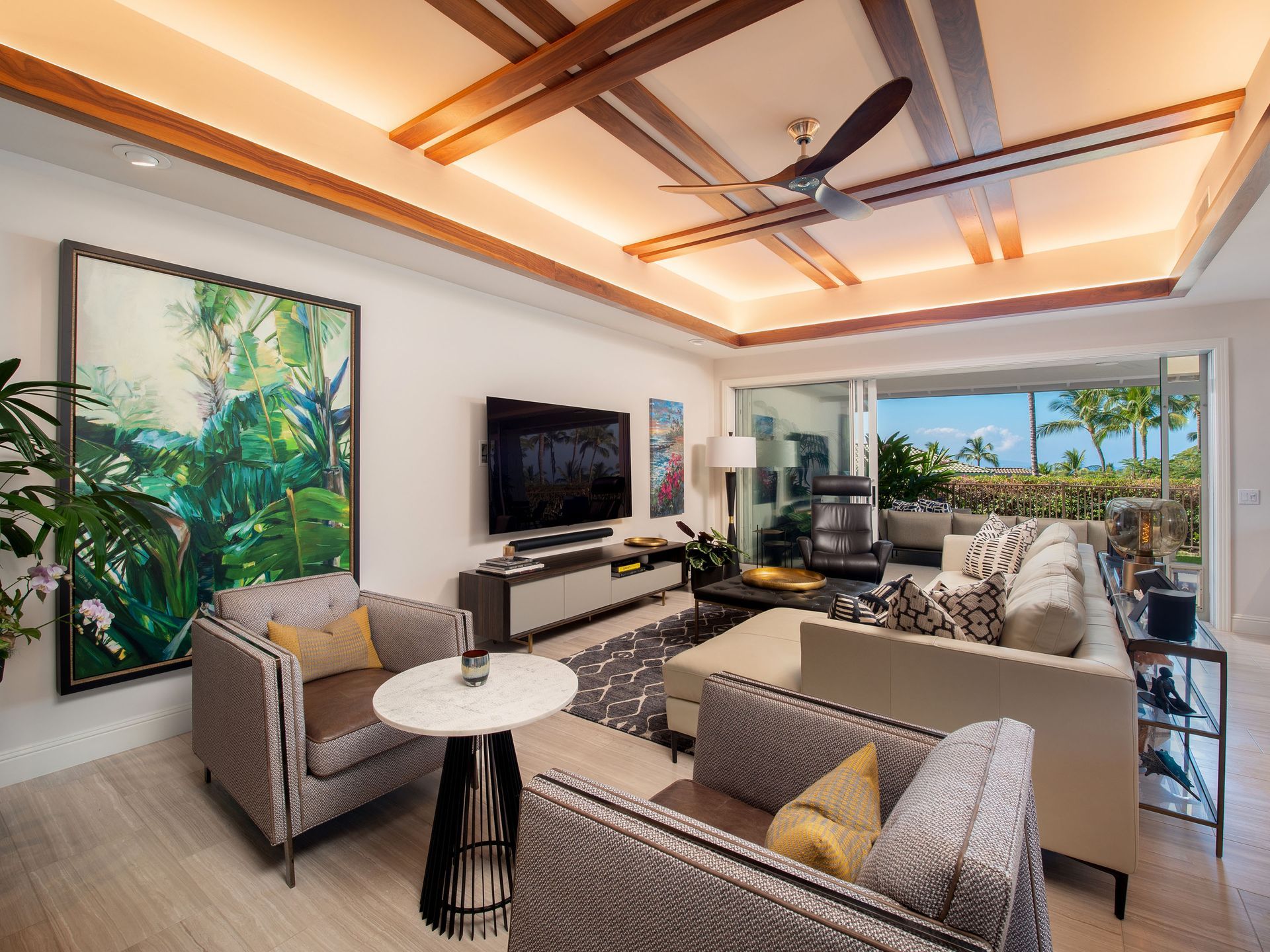 A living room with a couch , chairs , table and television.