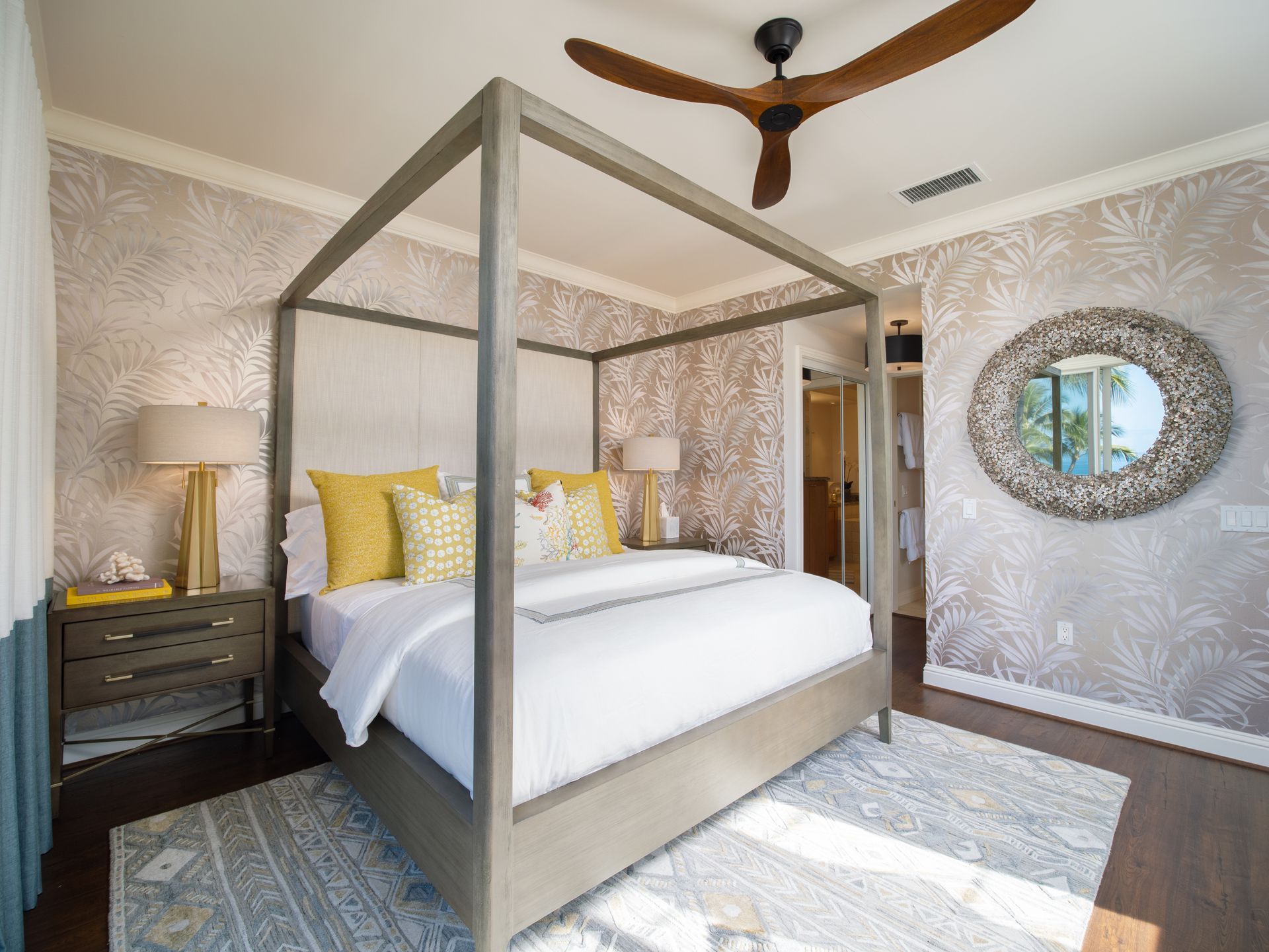 A bedroom with a canopy bed and a ceiling fan.