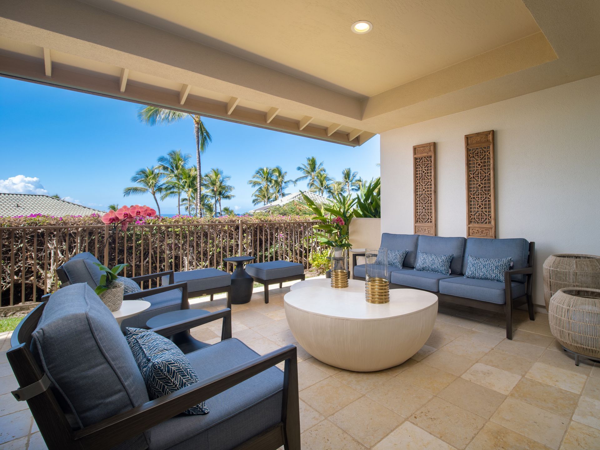 A patio with a couch , chairs , and a coffee table.