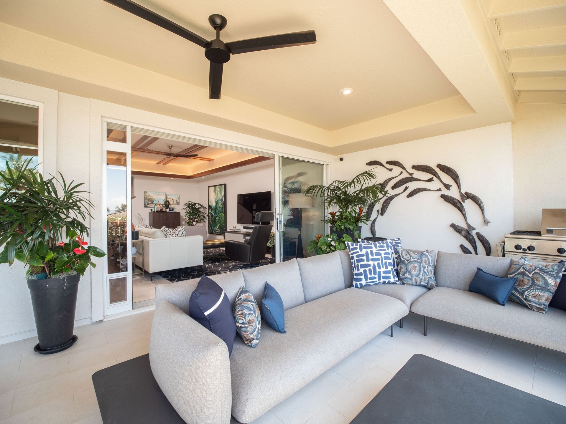 A living room with a couch and a ceiling fan