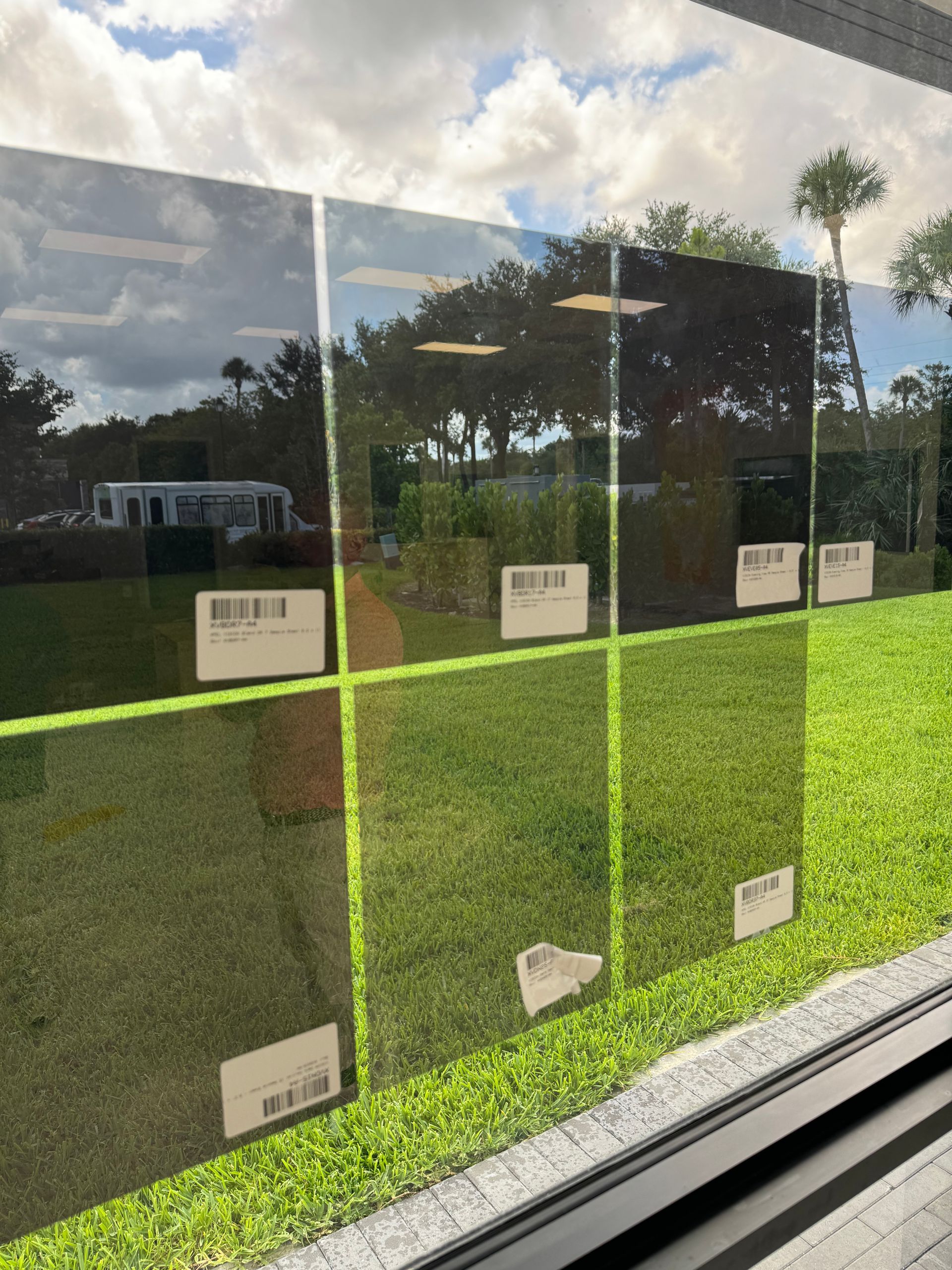 A window with a reflection of a grassy field in it.