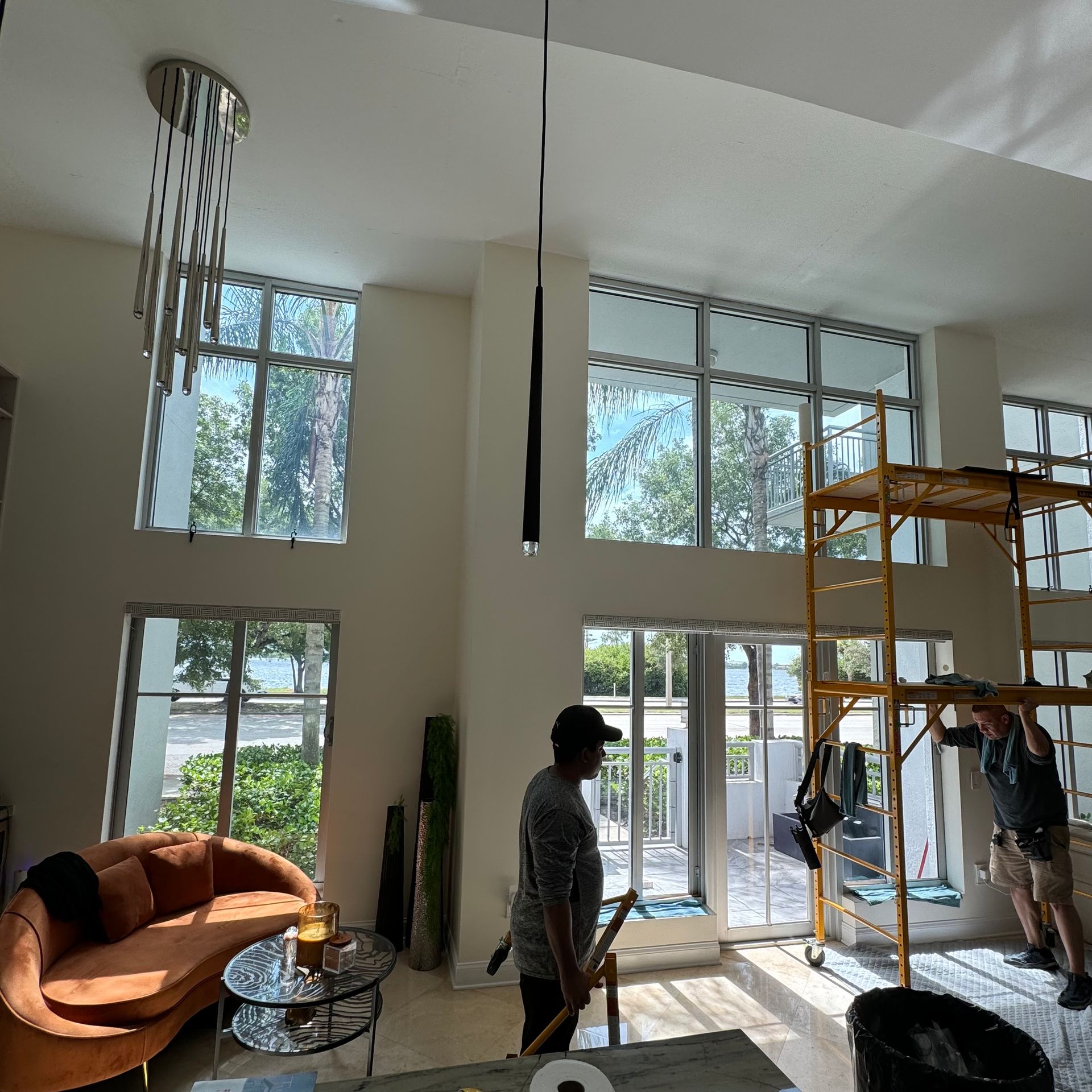 A living room with a couch and a scaffolding in the background