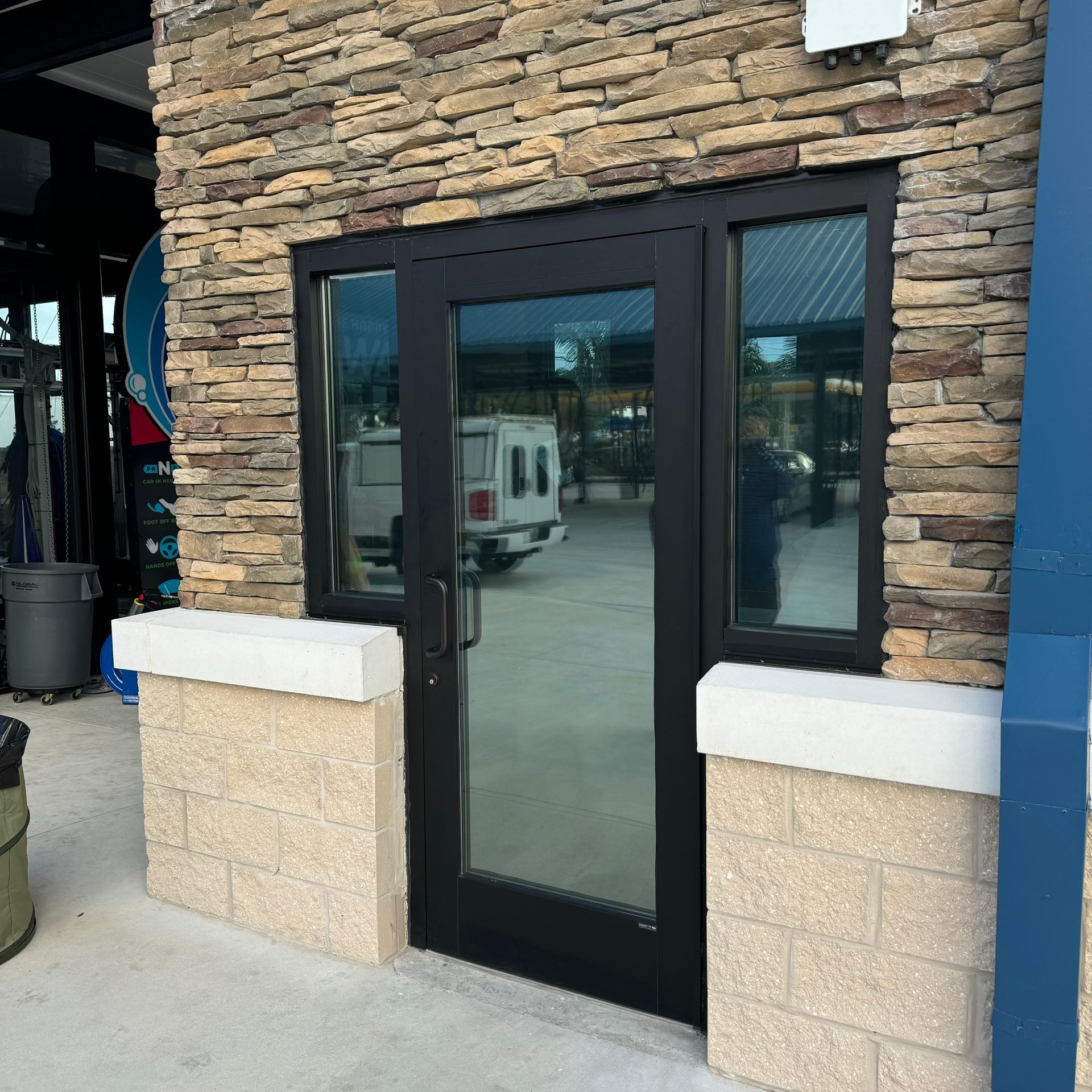 A brick building with a black door and a window
