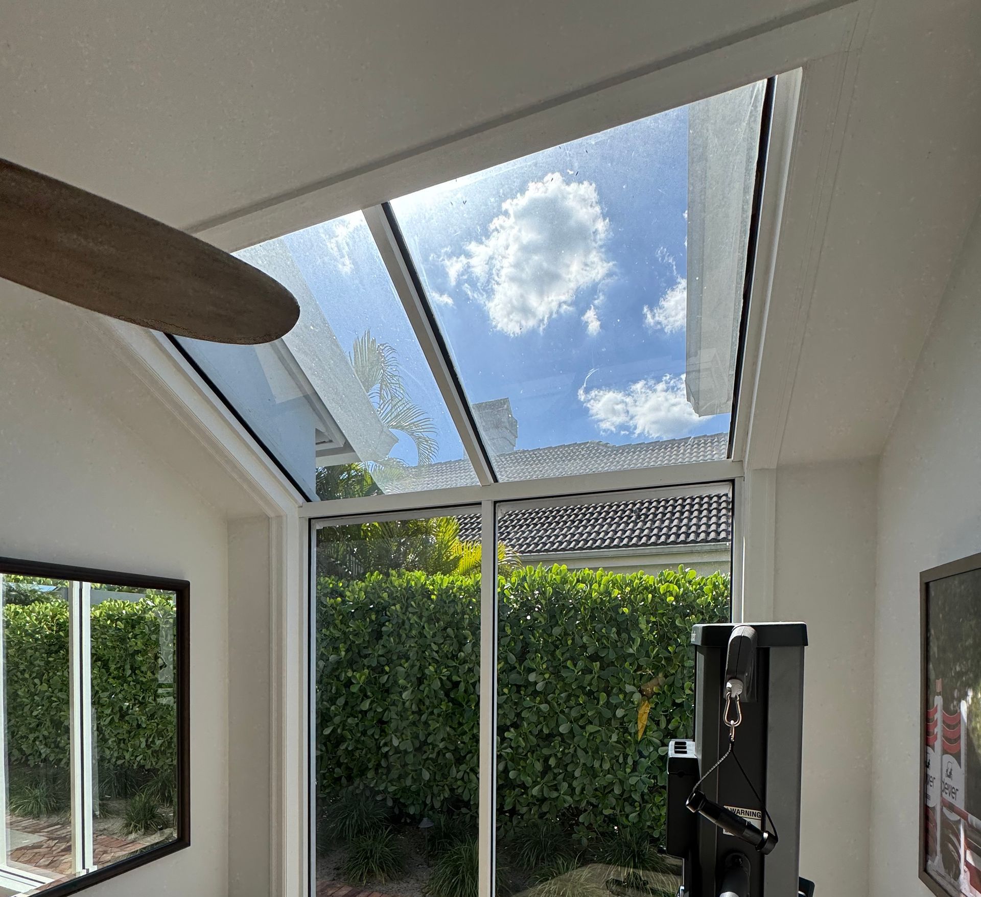 A room with a lot of windows and a ceiling fan