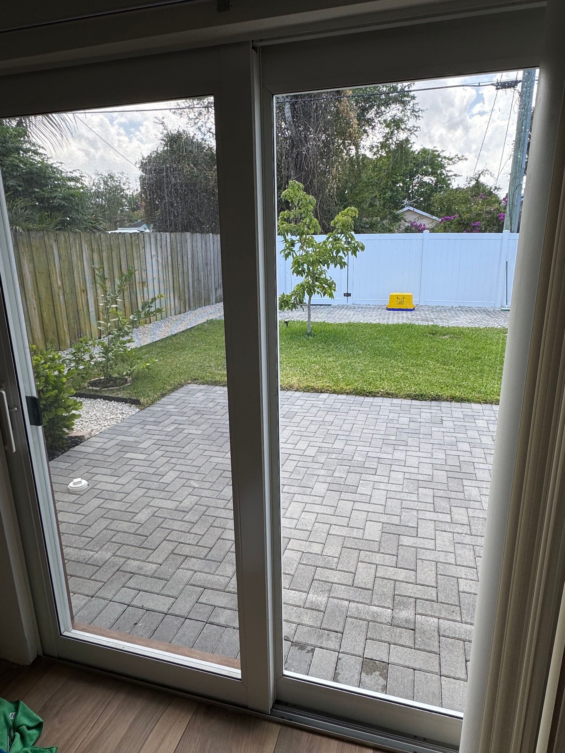 A room with a sliding glass door leading to a patio.