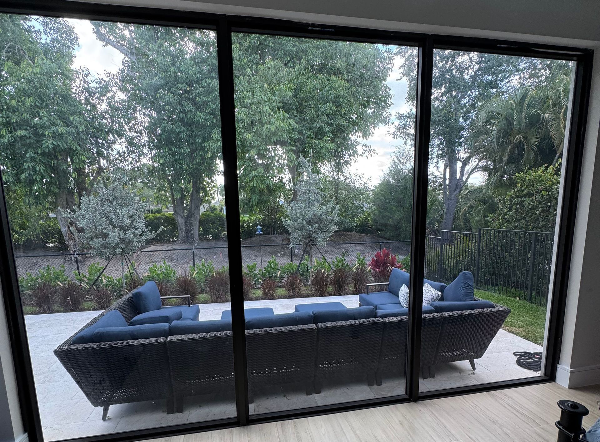 A living room with a couch and sliding glass doors leading to a patio.