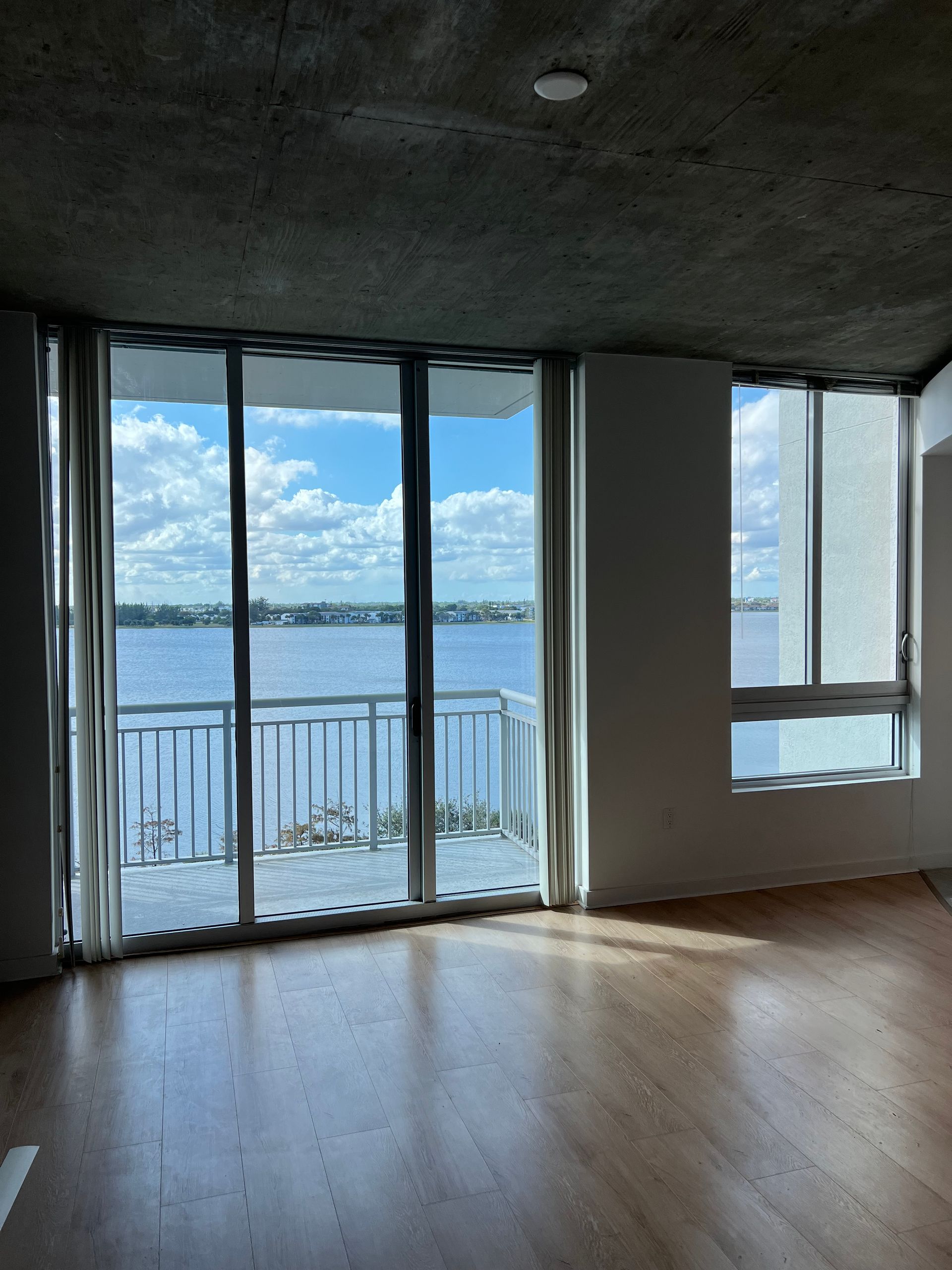 An empty room with a view of a body of water