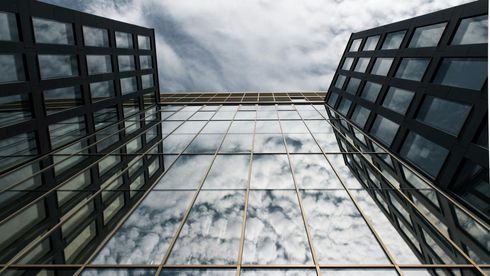 Looking up at a building with a cloudy sky in the background