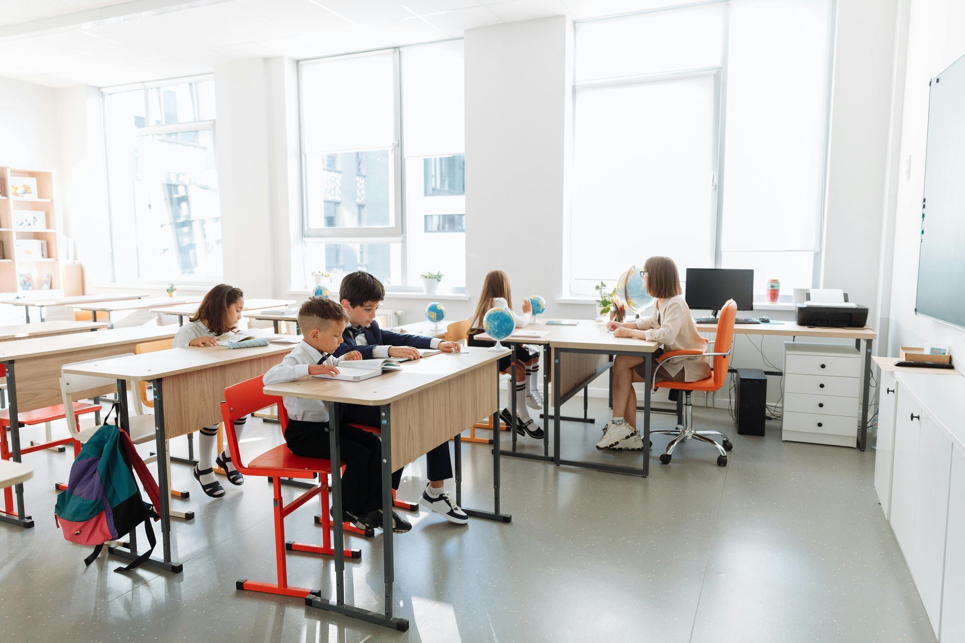 A group of children are sitting at desks in a classroom.