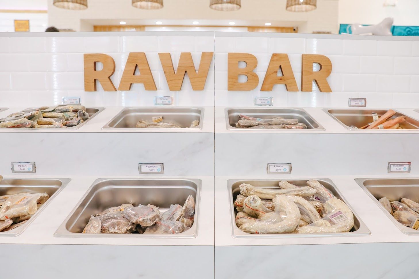 A raw bar in a restaurant with lots of trays of food.