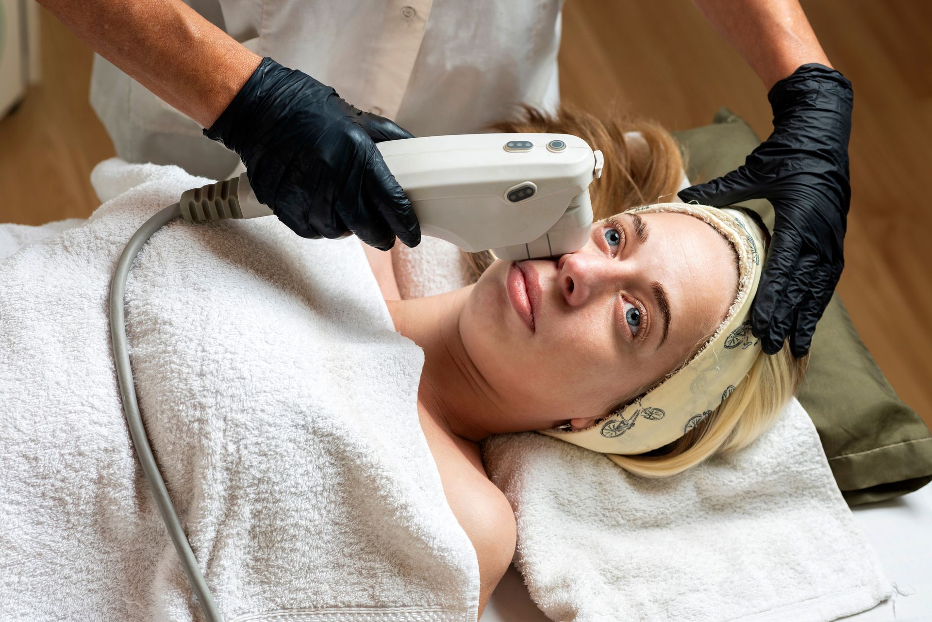 A woman is getting a facial treatment at a spa.