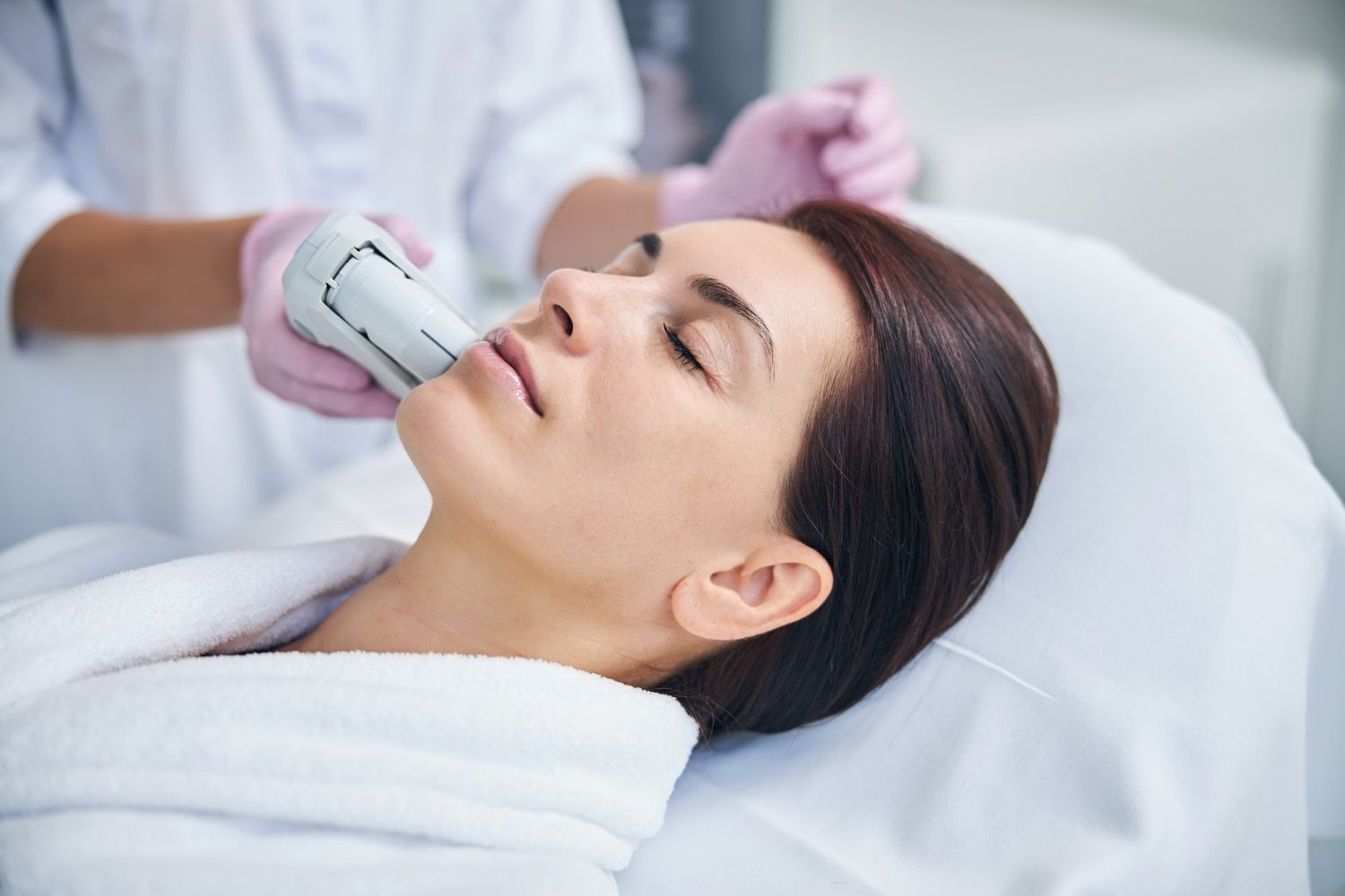 A woman is getting a facial treatment at a beauty salon.