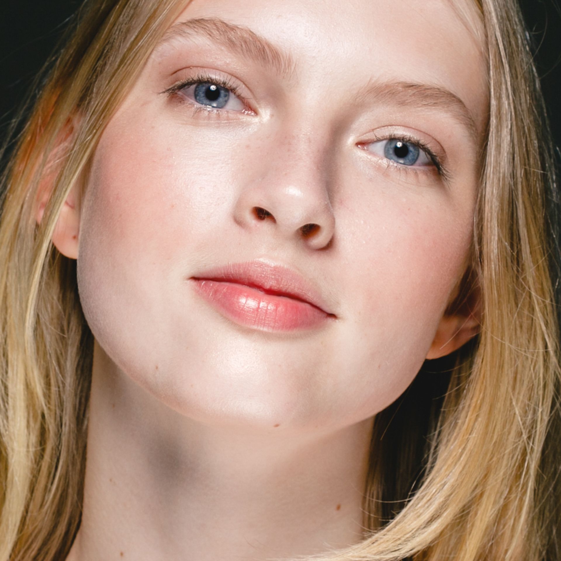 Woman with light skin, blue eyes, and blonde hair, looking at the viewer.