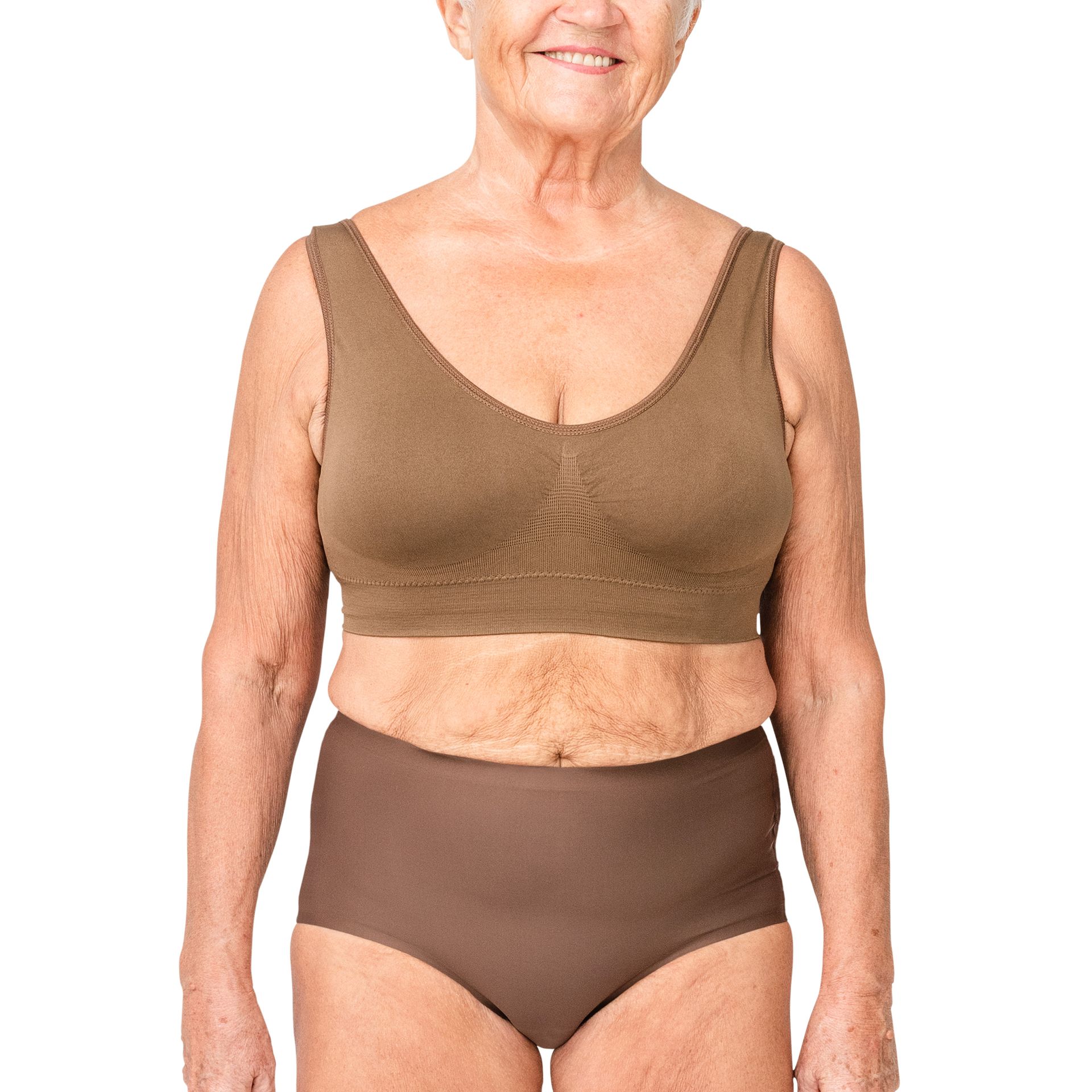 Woman in brown bra and underwear, smiling, standing against white background.