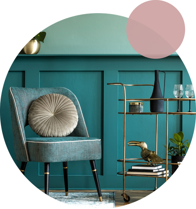 A statement chair against a vibrant teal background.