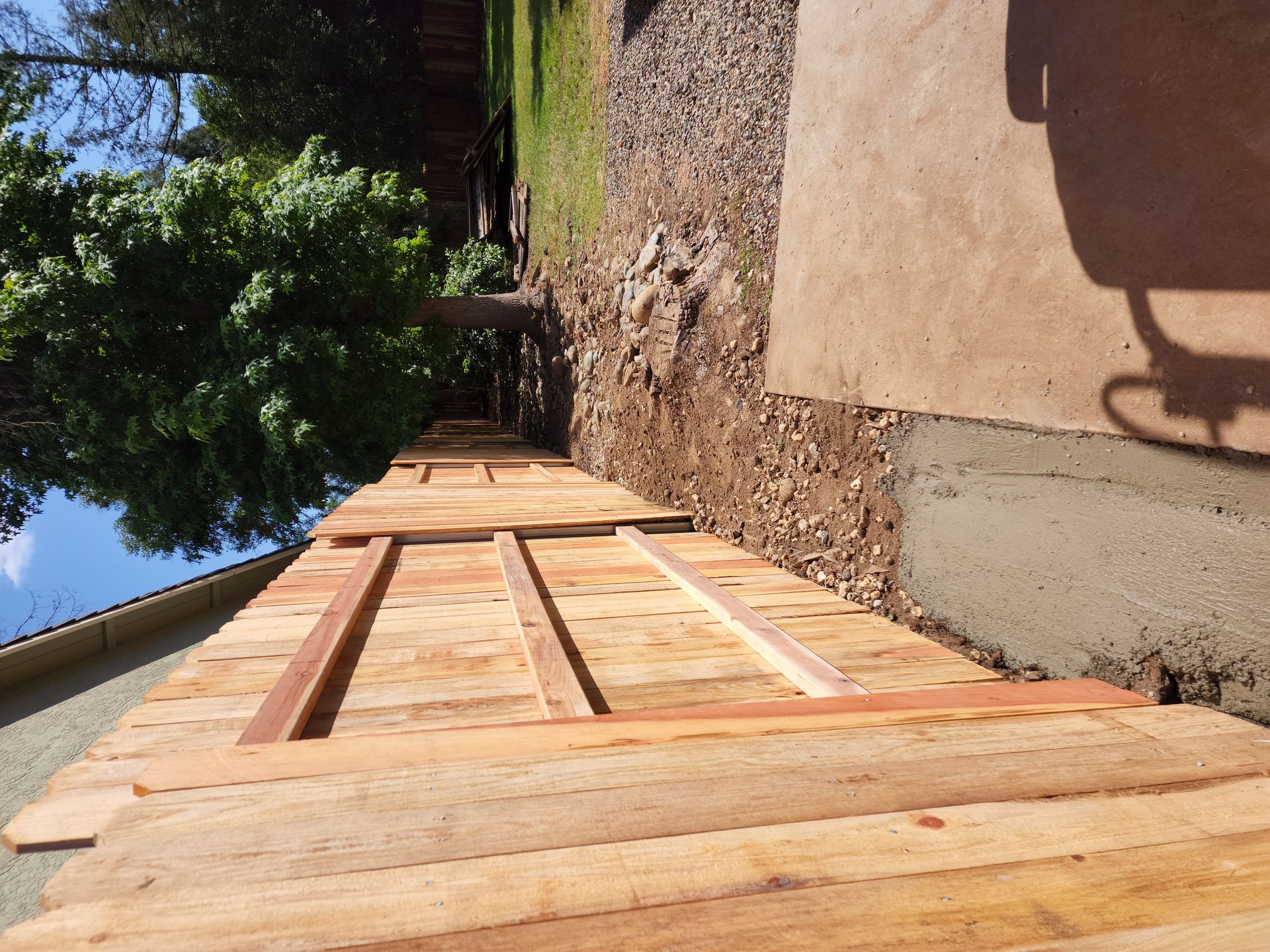 A wooden fence is being built in front of a house