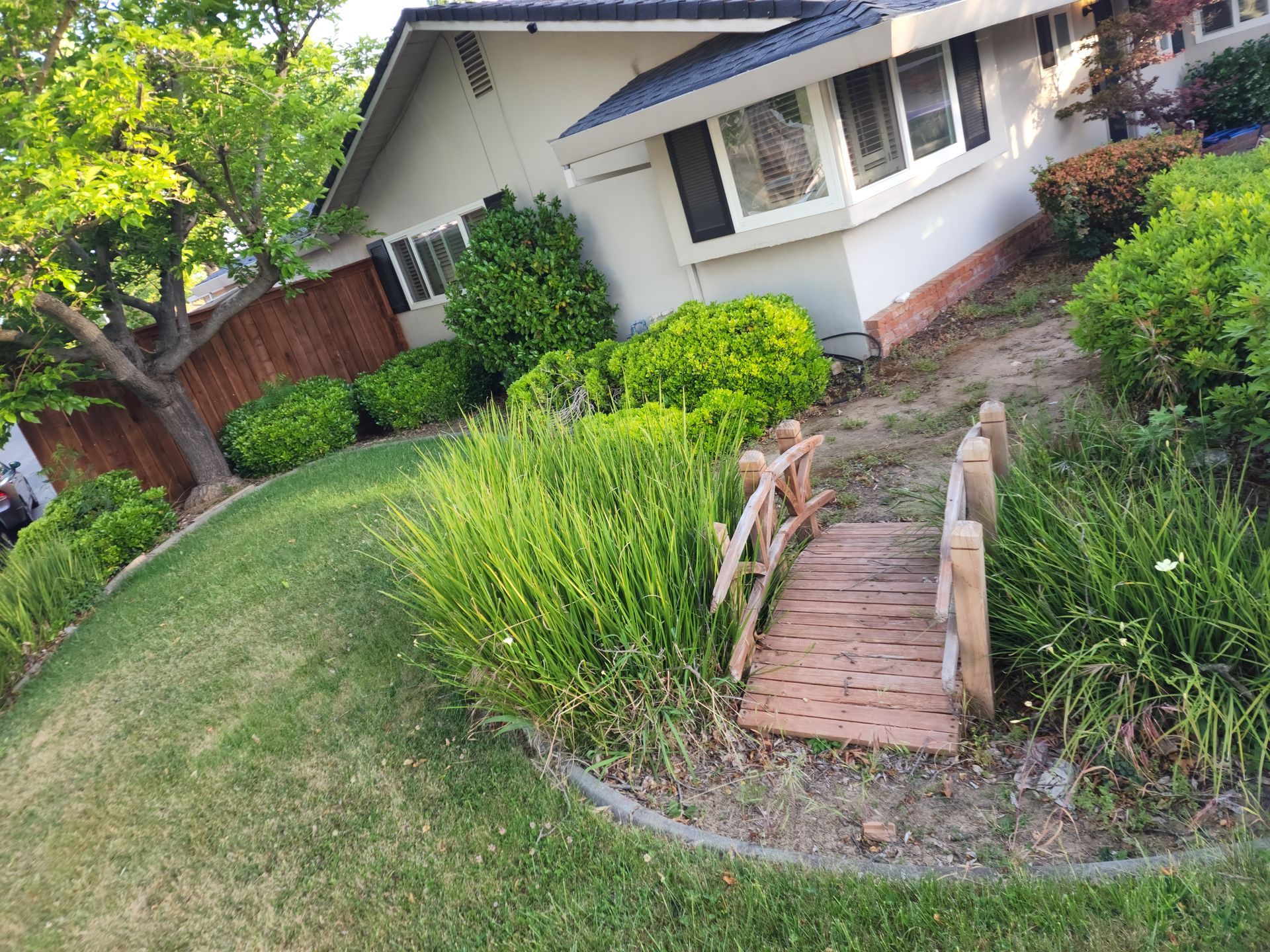 A house with a wooden bridge in front of it
