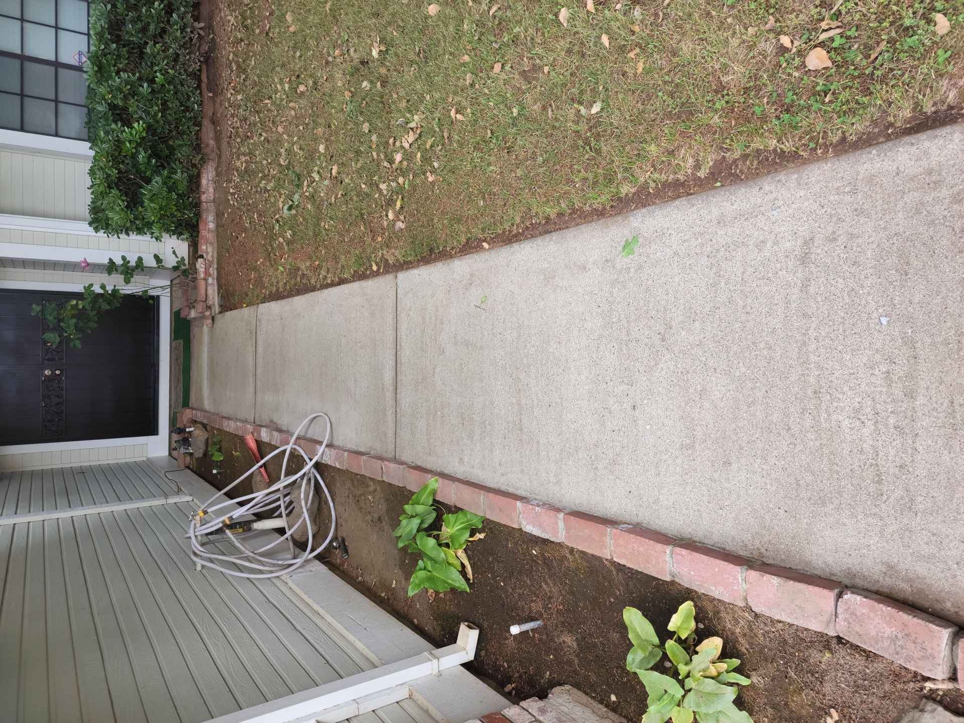 An aerial view of a sidewalk leading to a house.