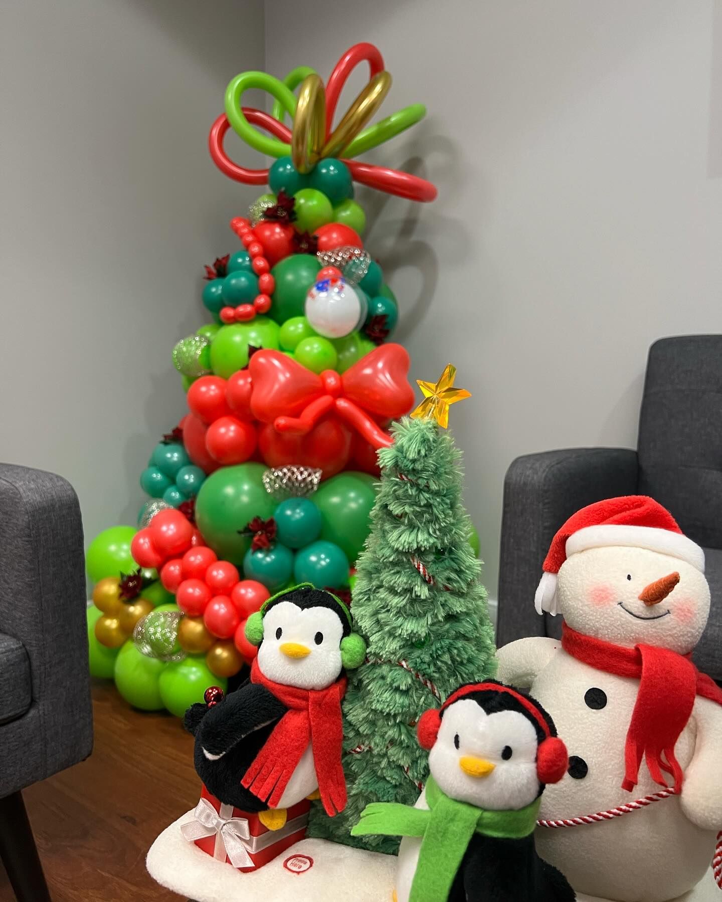 A christmas tree made of balloons and stuffed animals