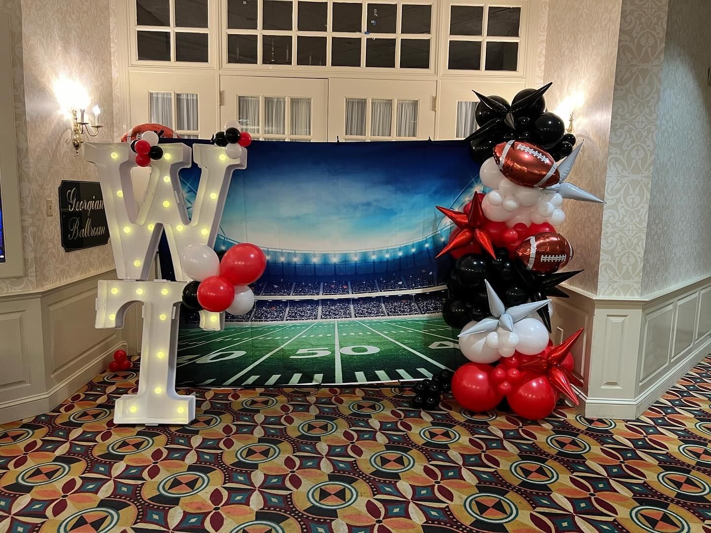 A room decorated with balloons and a large letter n.