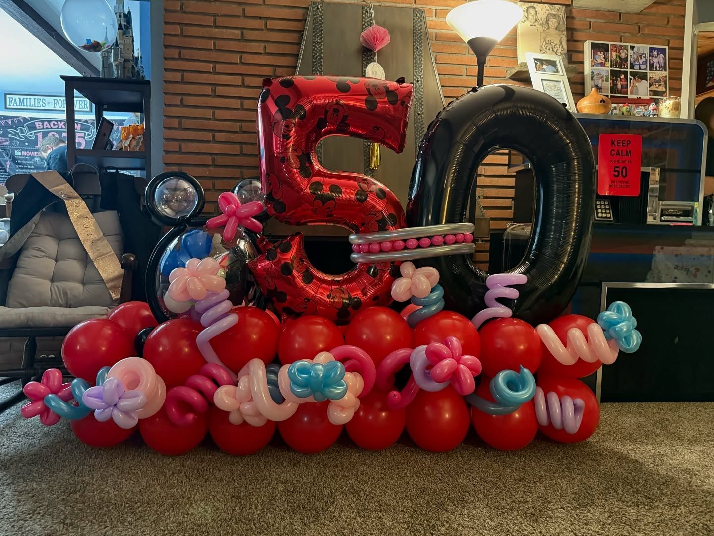 A bunch of balloons are sitting on the floor in a room.