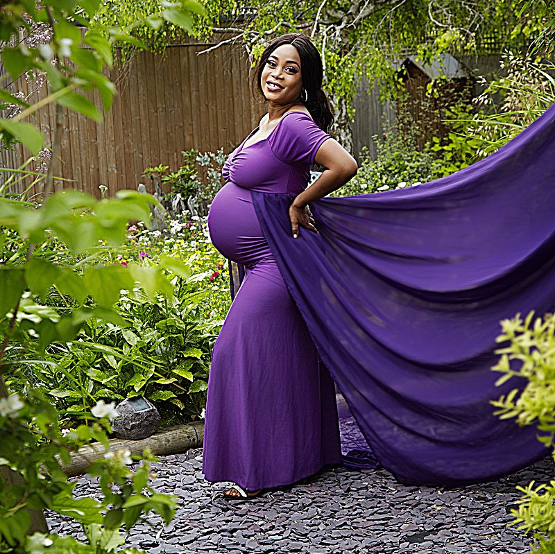 pregnant lady in black maternity dress outdoors, Oakley Studios celebration photoshoot in Luton Bedfordshire