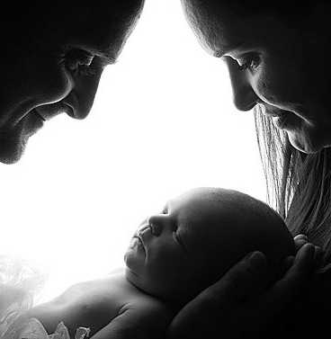family photoshoot with newborn baby asleep Oakley Studios celebration photoshoot in Luton Bedfordshire