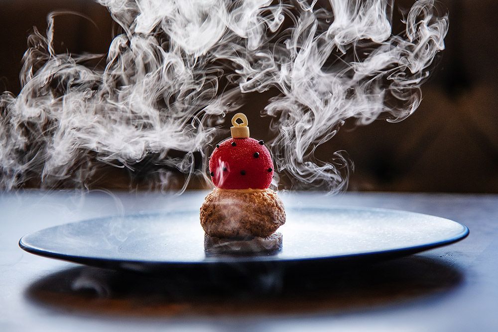 Paris House , Woburn , Michelin Guide, Oakley Studios Clementine parfait, spiced choux & chestnut crèmeux
The grand finale, the pièce de résistance, the bauble. Dry ice, clementine tea aroma and dive right in!