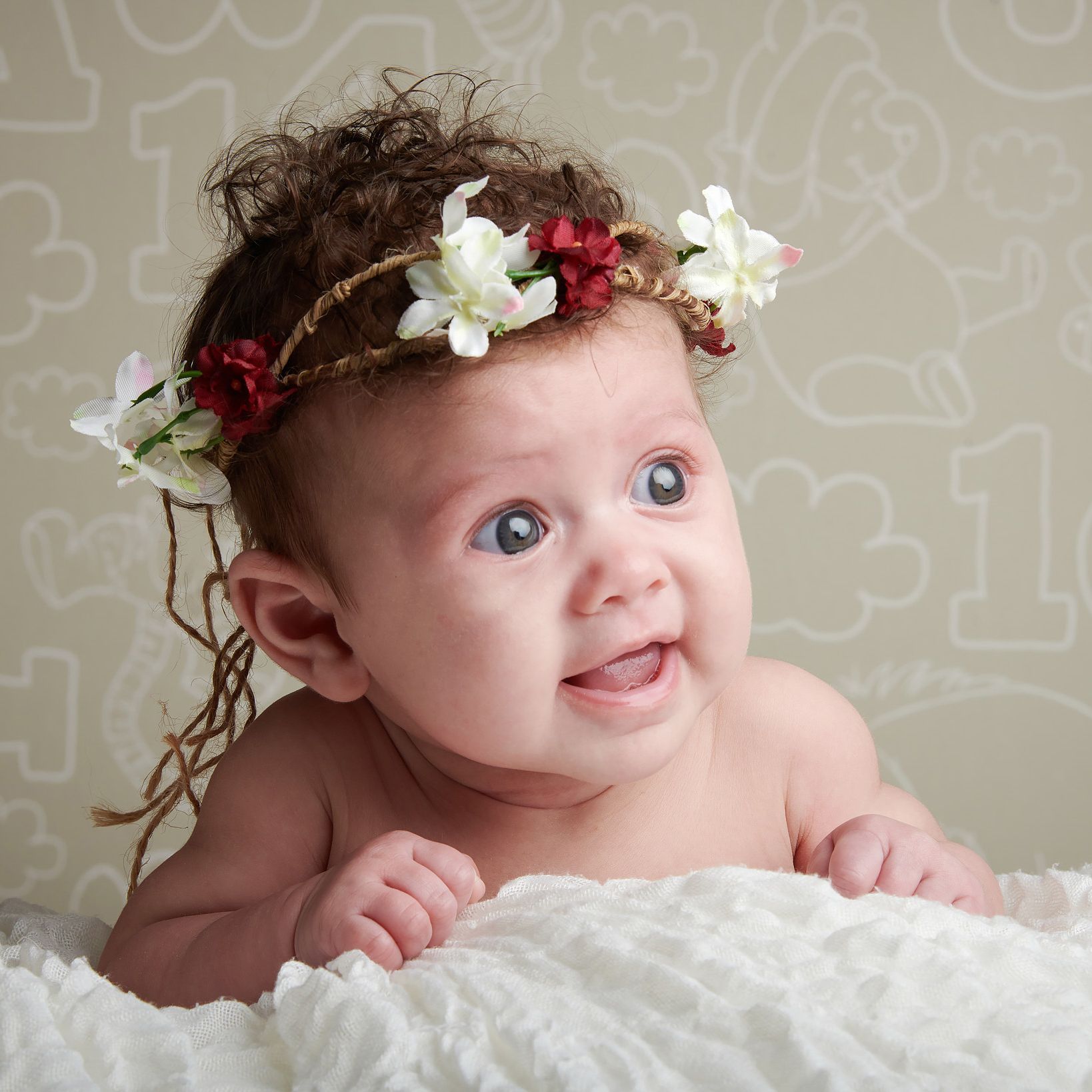 A baby with a flower crown on her head