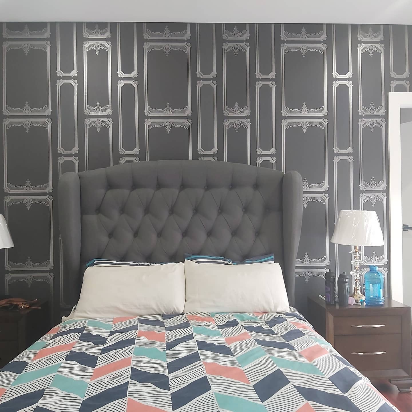 bed room with patterned wallpaper
