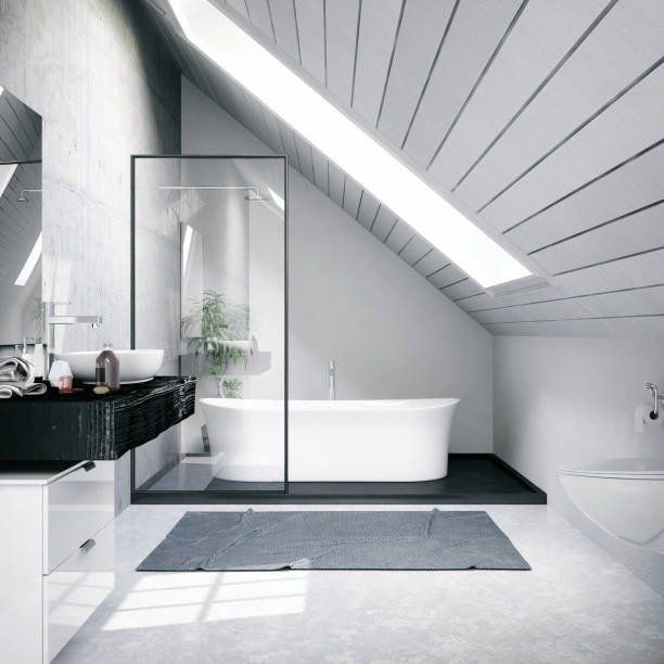 Modern bathroom with a soaking tub, glass shower, and angled ceiling.