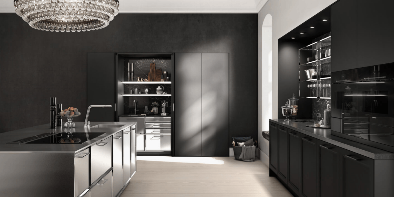Sleek black kitchen with island, cabinets, and chandelier. White floor and arch window brighten the dark space.
