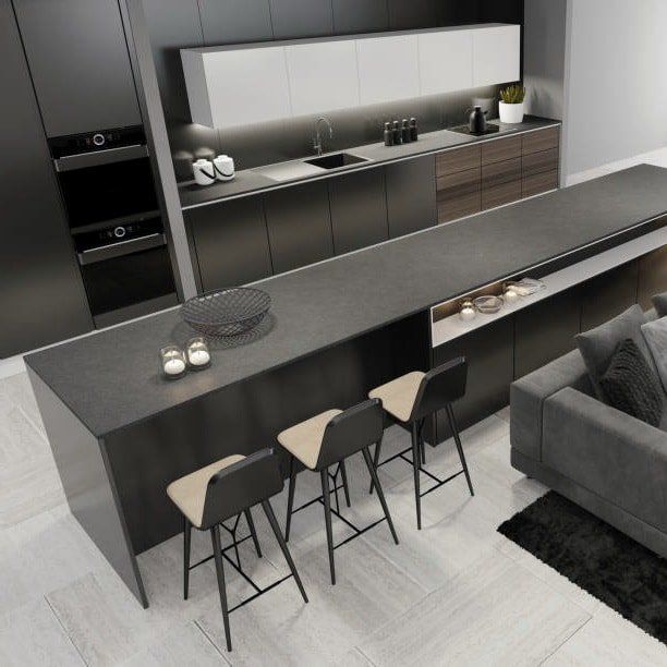 Modern gray kitchen with large island, bar stools, cabinets, oven, and sofa.