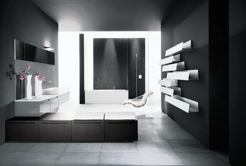 Modern minimalist bathroom with dark gray walls, white fixtures, and geometric shelving.