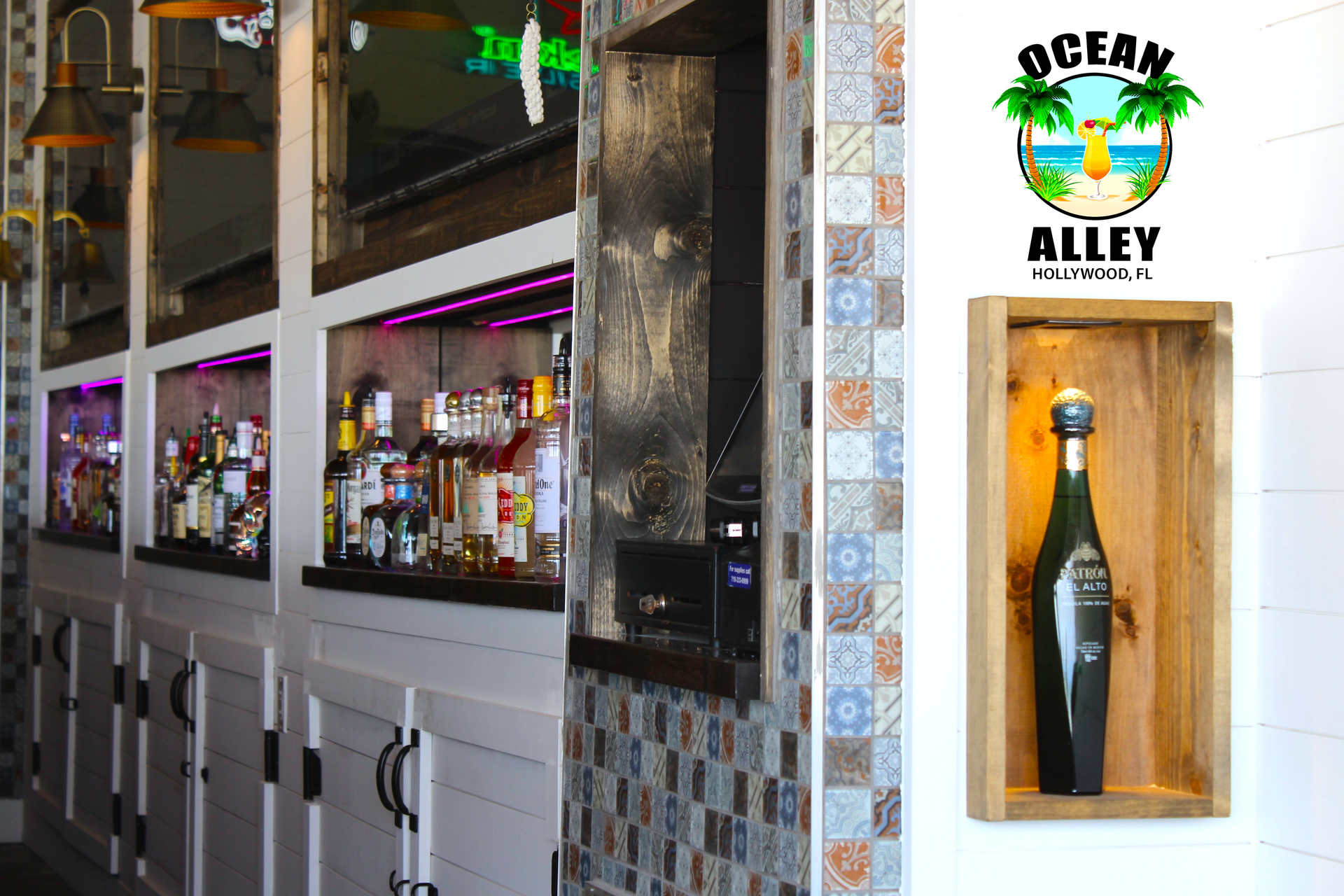 A bottle of wine is sitting on a shelf next to a sign that says ocean alley.