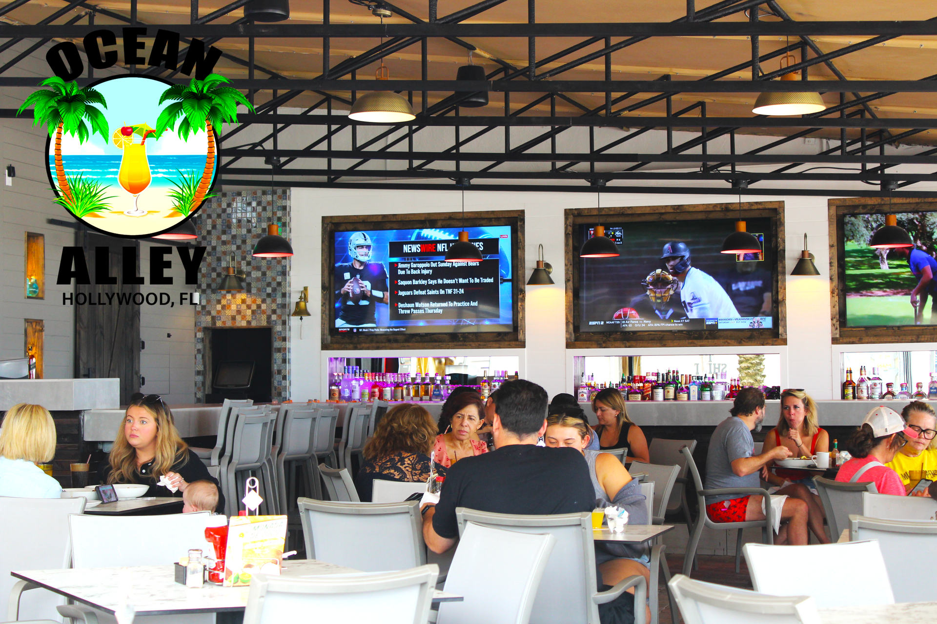 A group of people are sitting at tables in a restaurant called ocean alley